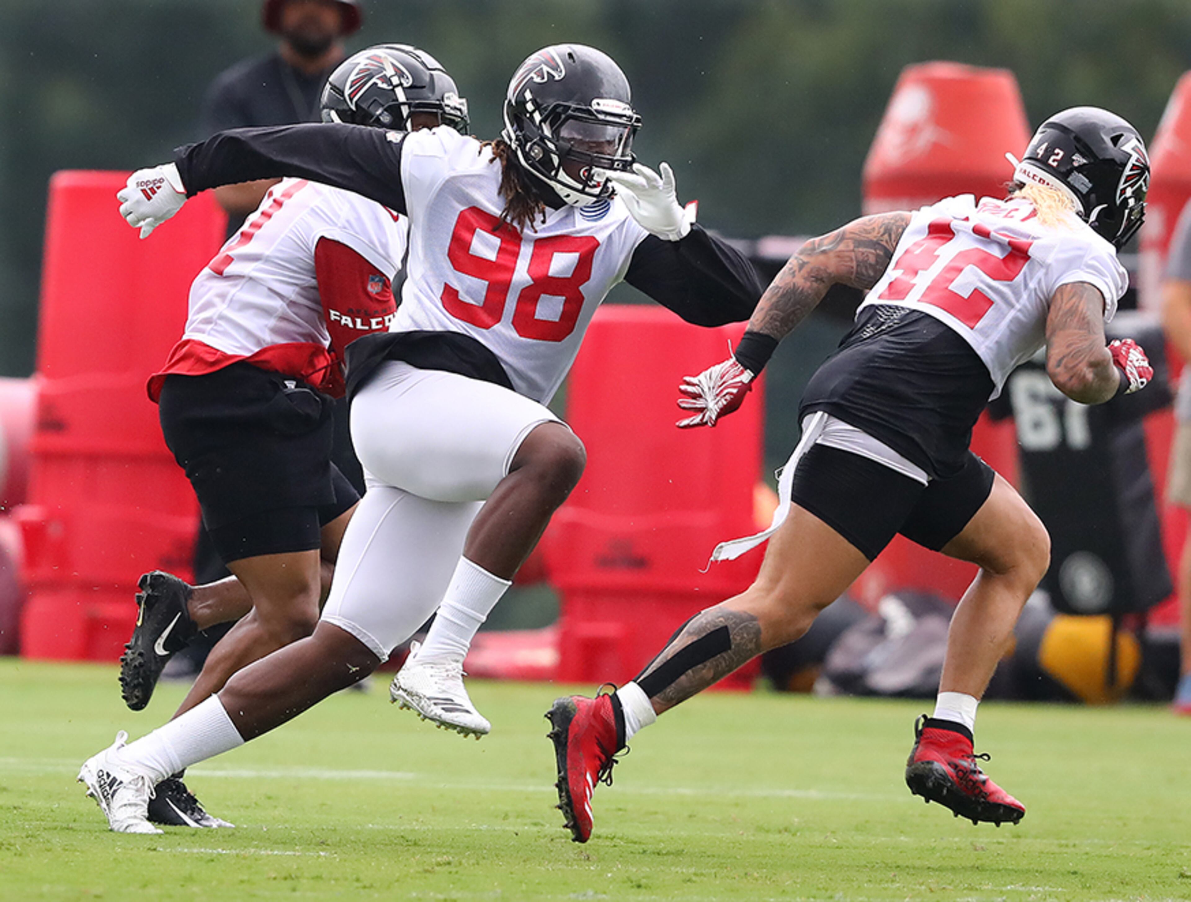 Falcons defensive end Takk McKinley (left), with linebacker Duke Riley, put a rush on the quarterback during a play on the second day of training camp practices Tuesday, July 23, 2019, in Flowery Branch.