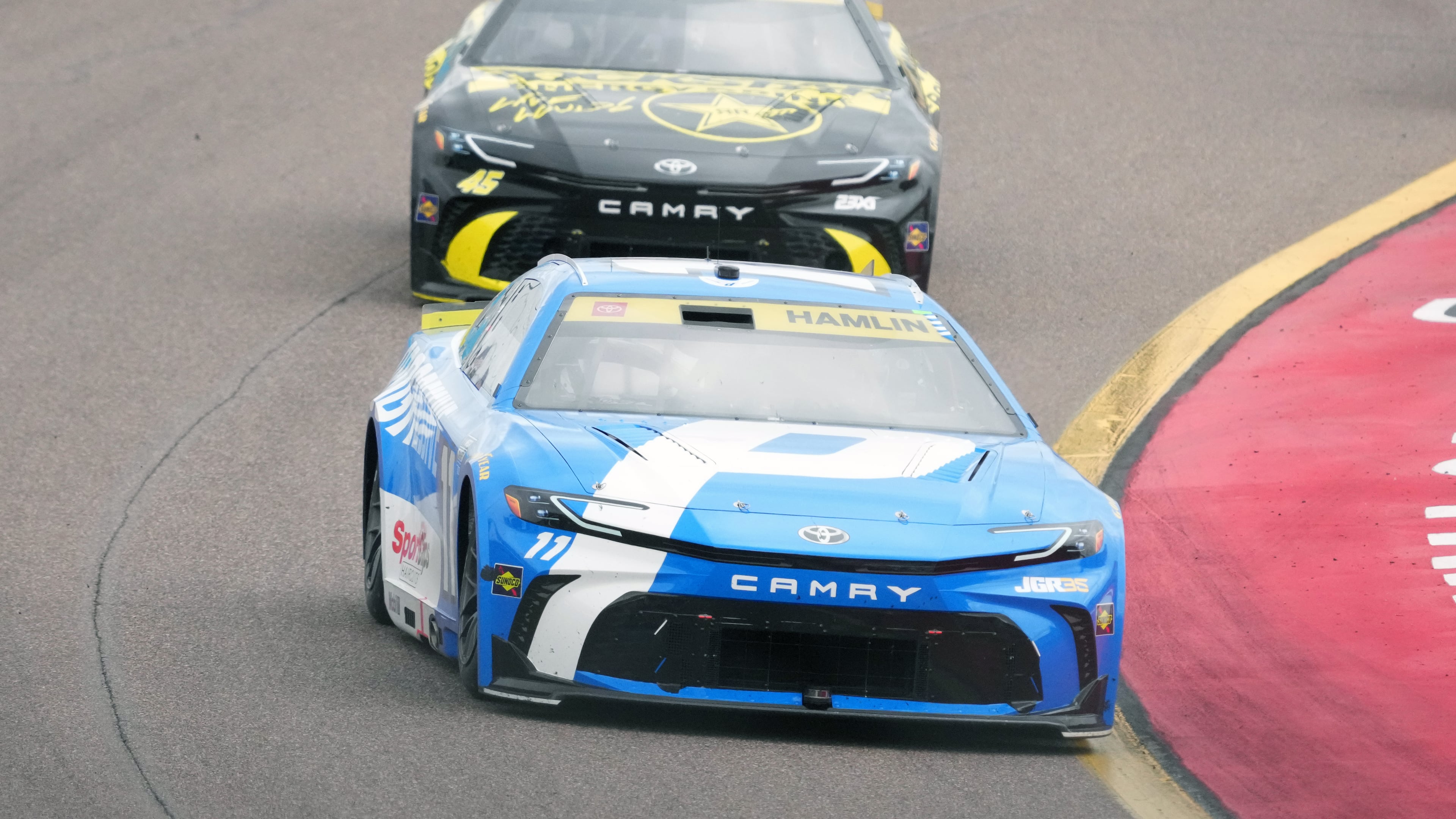 Denny Hamlin (11) leads Tyler Reddick on the 30th lap during a NASCAR Cup Series auto race Sunday, Oct. 18, 2026, in Avondale, Ariz. (AP Photo/Rick Scuteri)