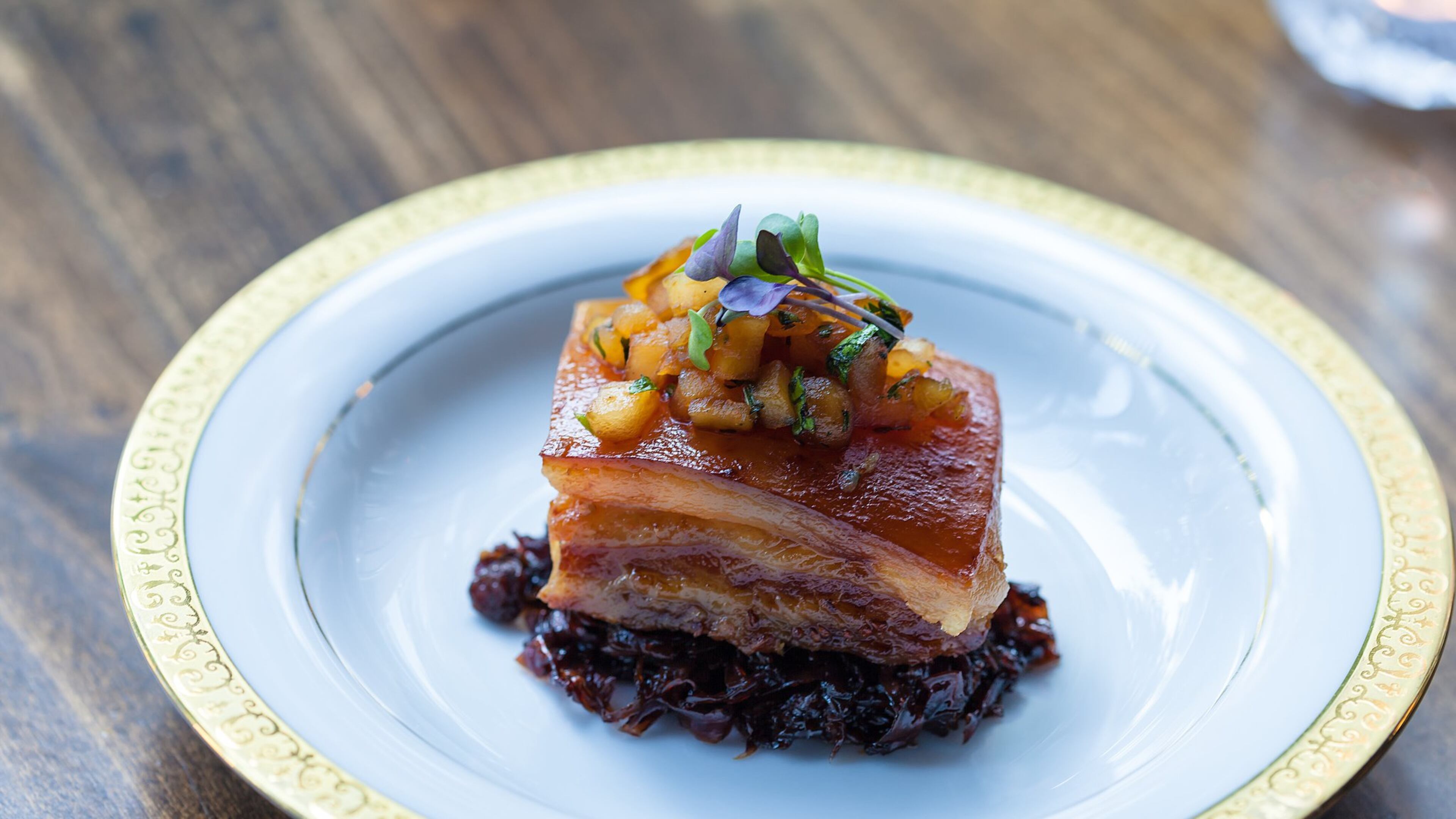 A succulent slab of pork belly, served in a nest of tart, balsamic-glazed cabbage, at the Consulate. (Contributed)