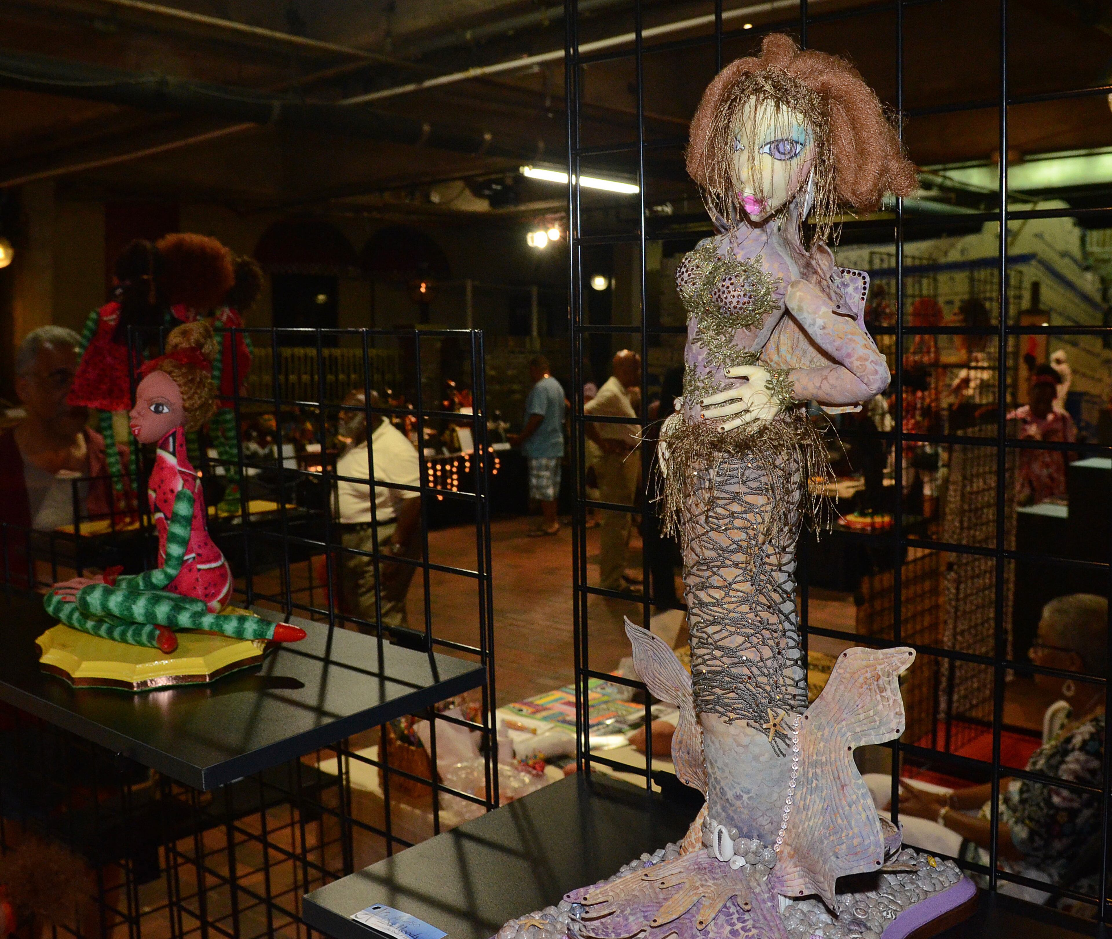 A black mermaid, by soft sculpture artist Angela Ferguson, "said to have lured incoming slaves from their approaching ships" along the South Carolina coastline, casts an alluring eye toward passersby at the 19th Annual Heritage Arts and Soul Festival at Underground Atlanta. The event features the work of over 30 artist, featuring fine art and wearable art ,plus an emerging artist pavillion, fashion show. (CHRIS HUNT/SPECIAL)