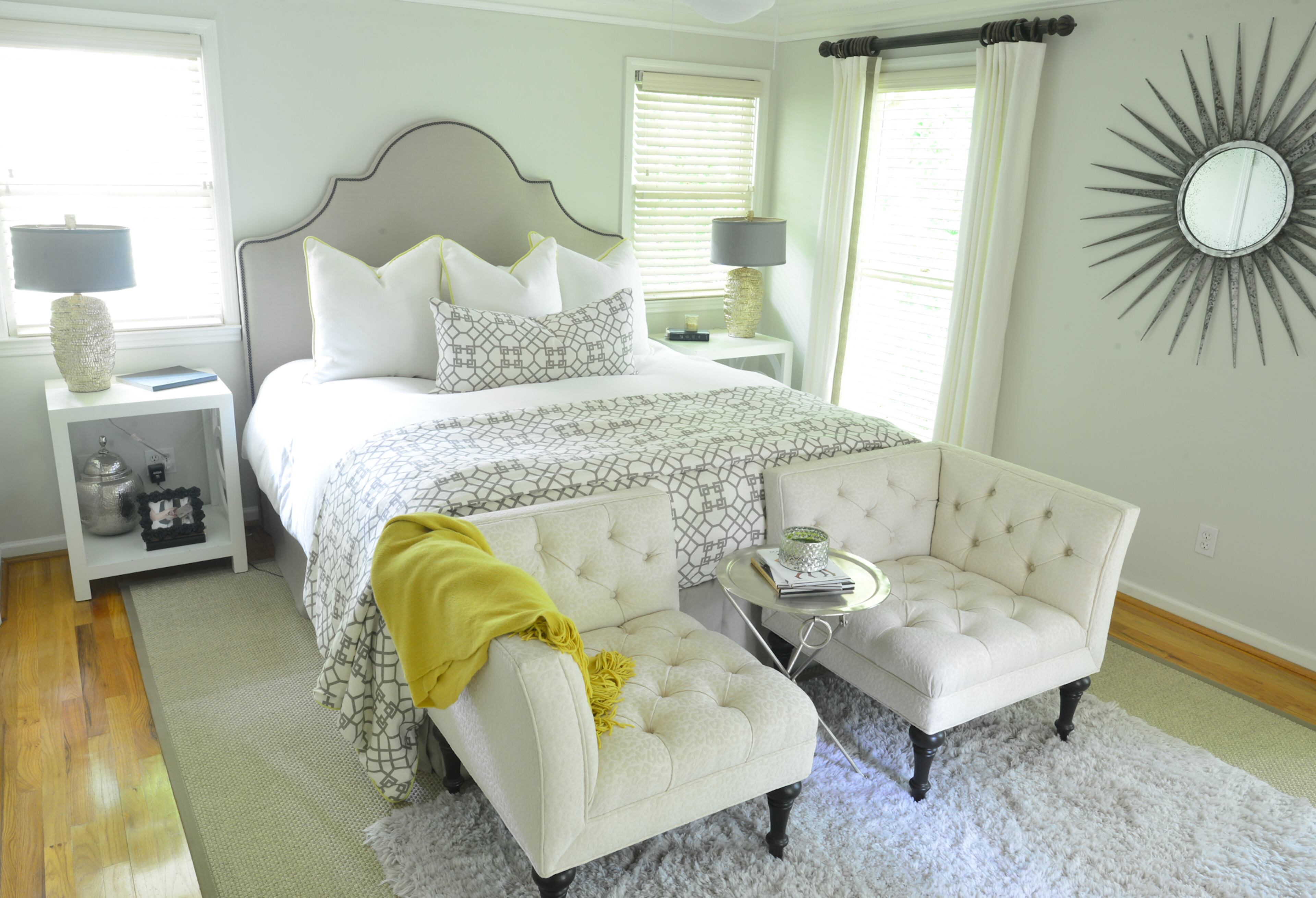 Squared off Bernhardt chairs are positioned in front of the bed, which has a custom-made headboard, are covered with a monotone cheetah print.