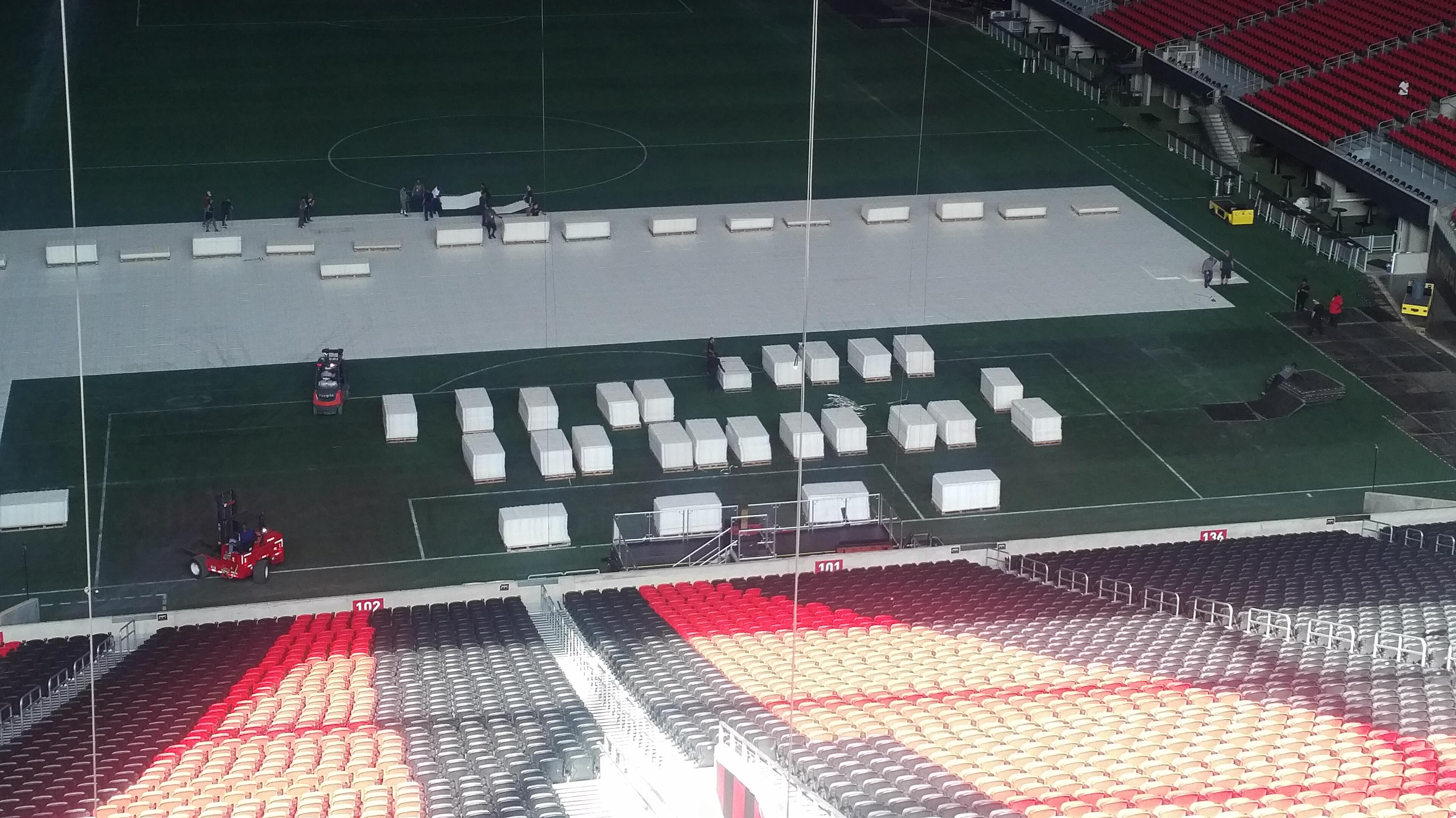 Stage crews started laying the flooring for Kenny Chesney's setup on Monday morning at Mercedes-Benz Stadium. Photo: Melissa Ruggieri/AJC