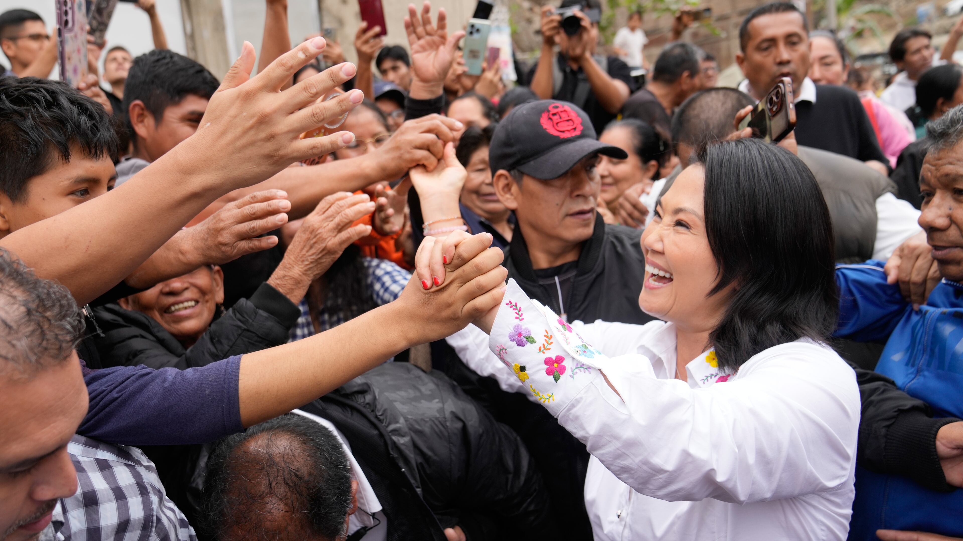 Presidential candidate Keiko Fujimori, of the Popular Force party, greets supporters before voting in the presidential runoff election in Lima, Peru, Sunday, June 7, 2026. (AP Photo/Martin Mejia)