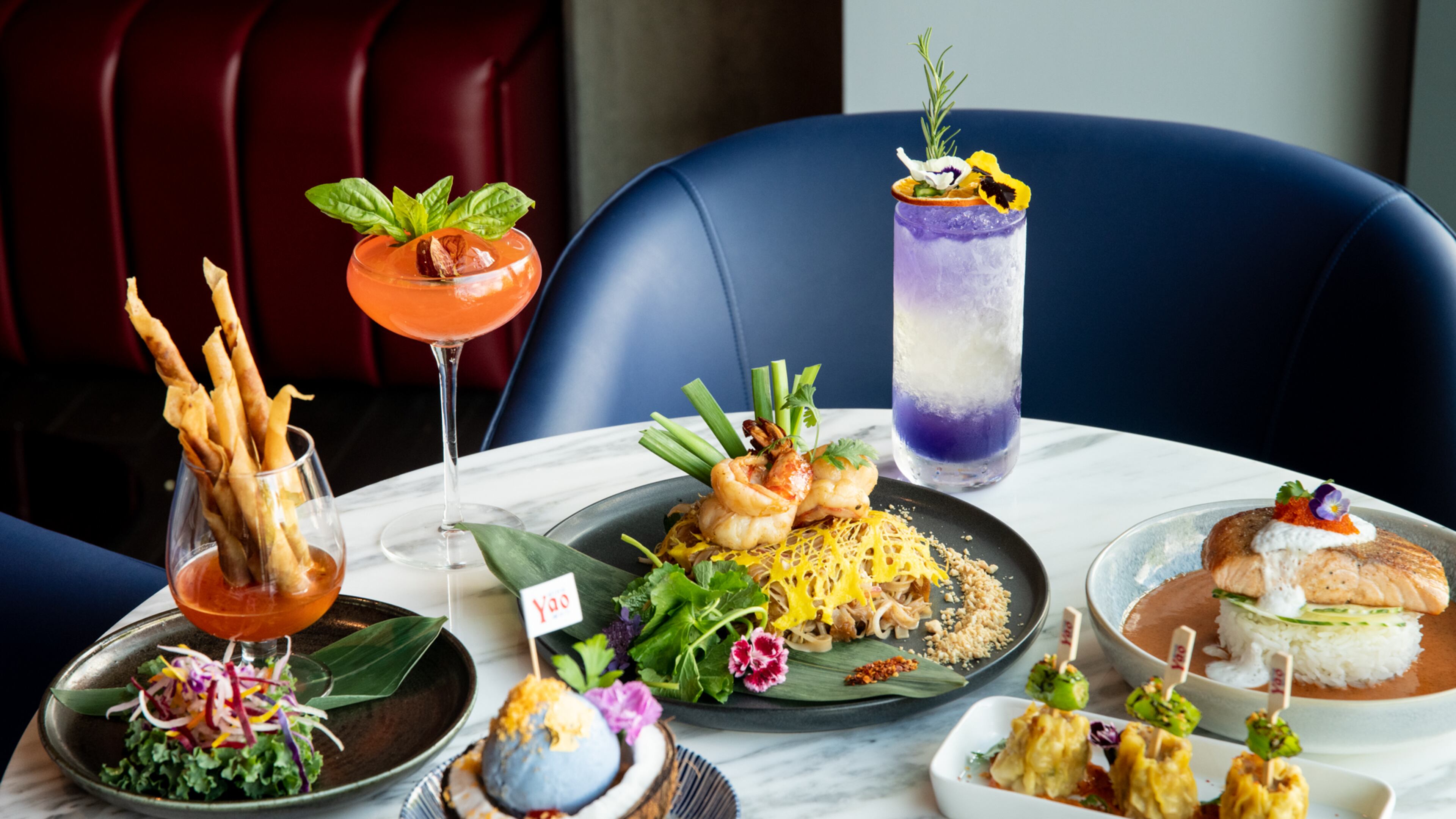 Yao, an upscale Thai-Chinese restaurant and bar, just opened in Dunwoody. Shown here are Taro Rolls (clockwise, from left), Ms. Yao cocktail, Jumbo Prawn Pad Thai, Mr. Yao cocktail, Salmon Panang, Yao Dumplings and Yao's Ice Cream. (Mia Yakel for The Atlanta Journal-Constitution)