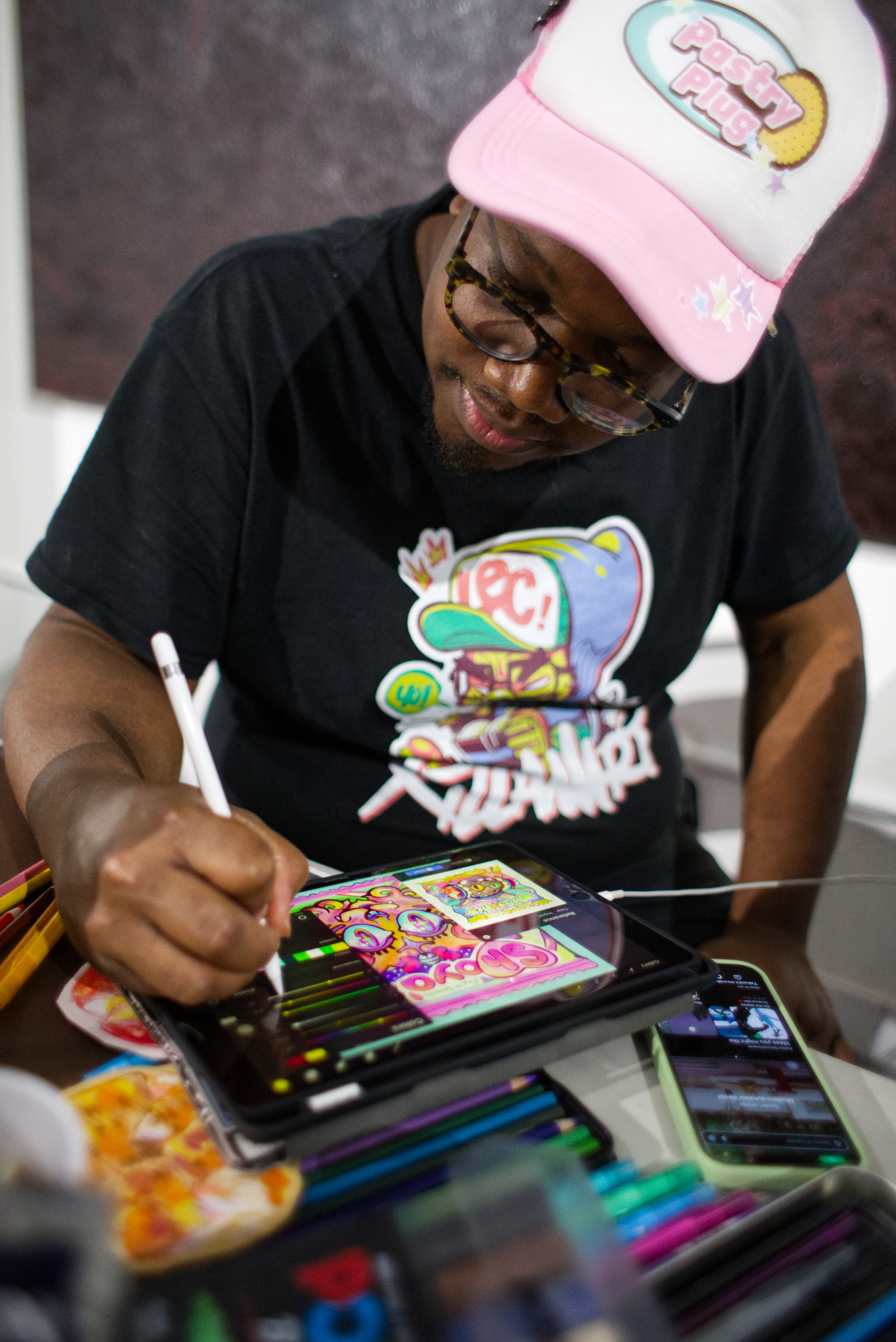 Atlanta artist MonkPanda focuses while drawing on his tablet. A guiding tenet of checking your ego at the door keeps the energy of High Contrast warm and welcoming. (Courtesy of Dustin Timbrook)