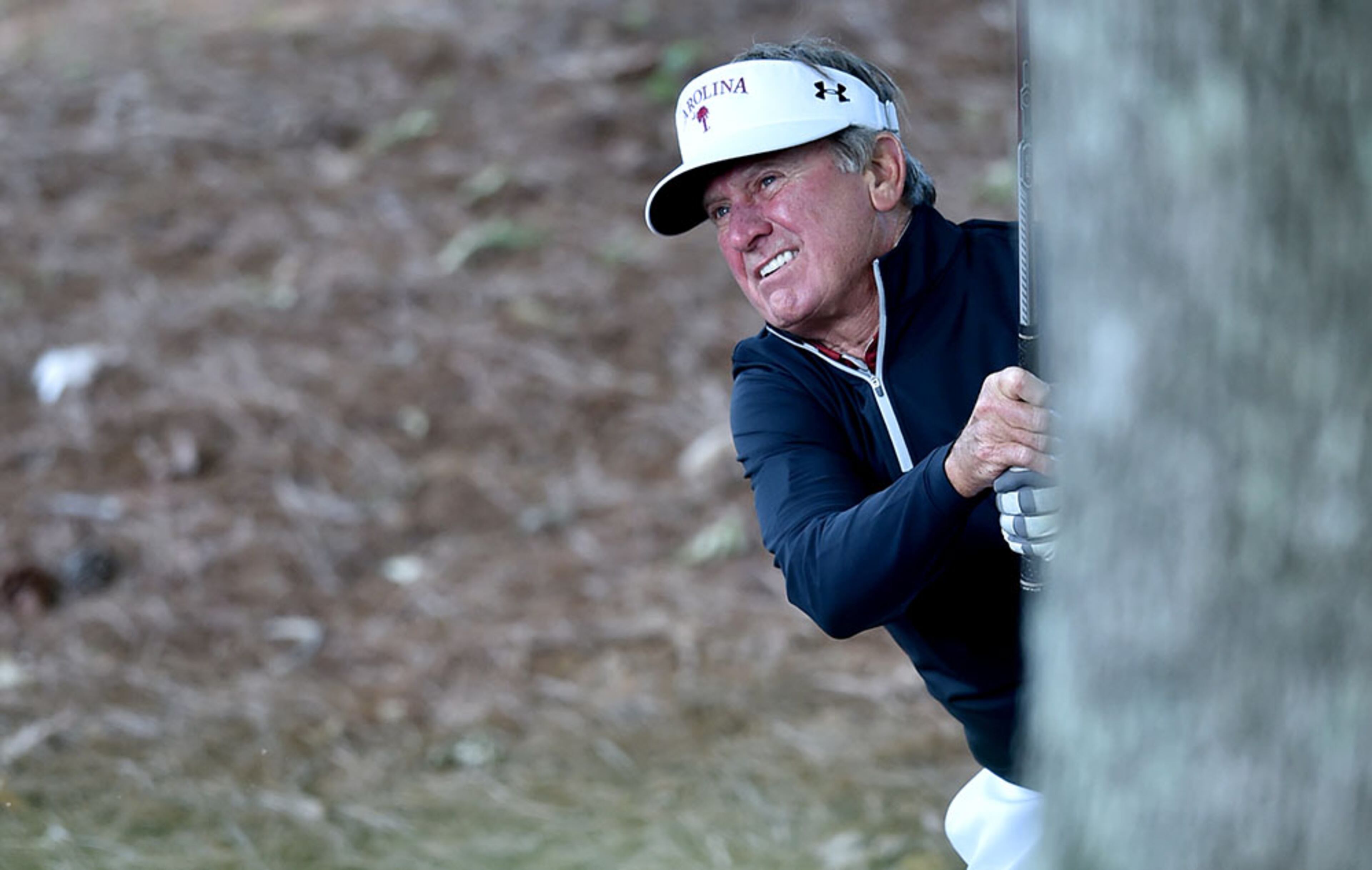 University of South Carolina head football coach Steve Spurrier hits from the rough on the 9th hole during the Chick -fil-A Peach Bowl Challenge at Reynolds Plantation at Lake Oconee. The event features 13 NCAA head coaches and former athletes and celebrities from the same school competing against their rivals for a share of a $520,000 scholarship purse.