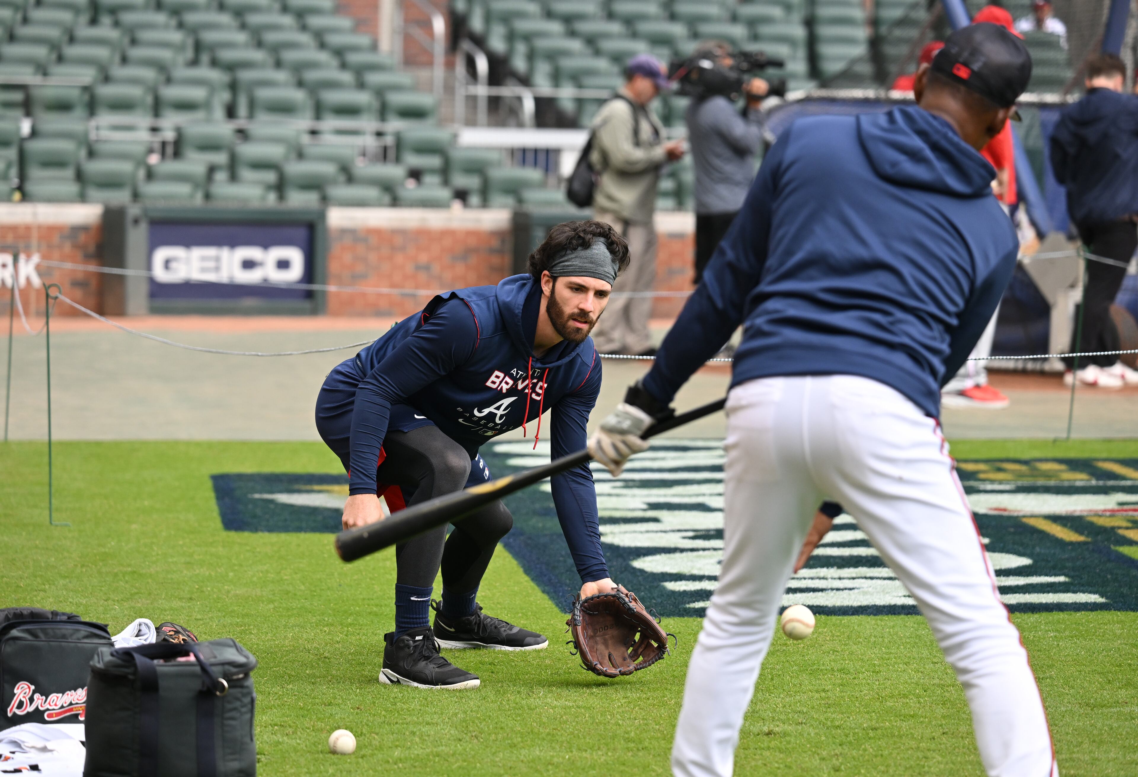 Shortstop Dansby Swanson gets in some pre-game work with coach Ron Washington before Tuesday's Braves-Phillies playoff game at Truist Park.