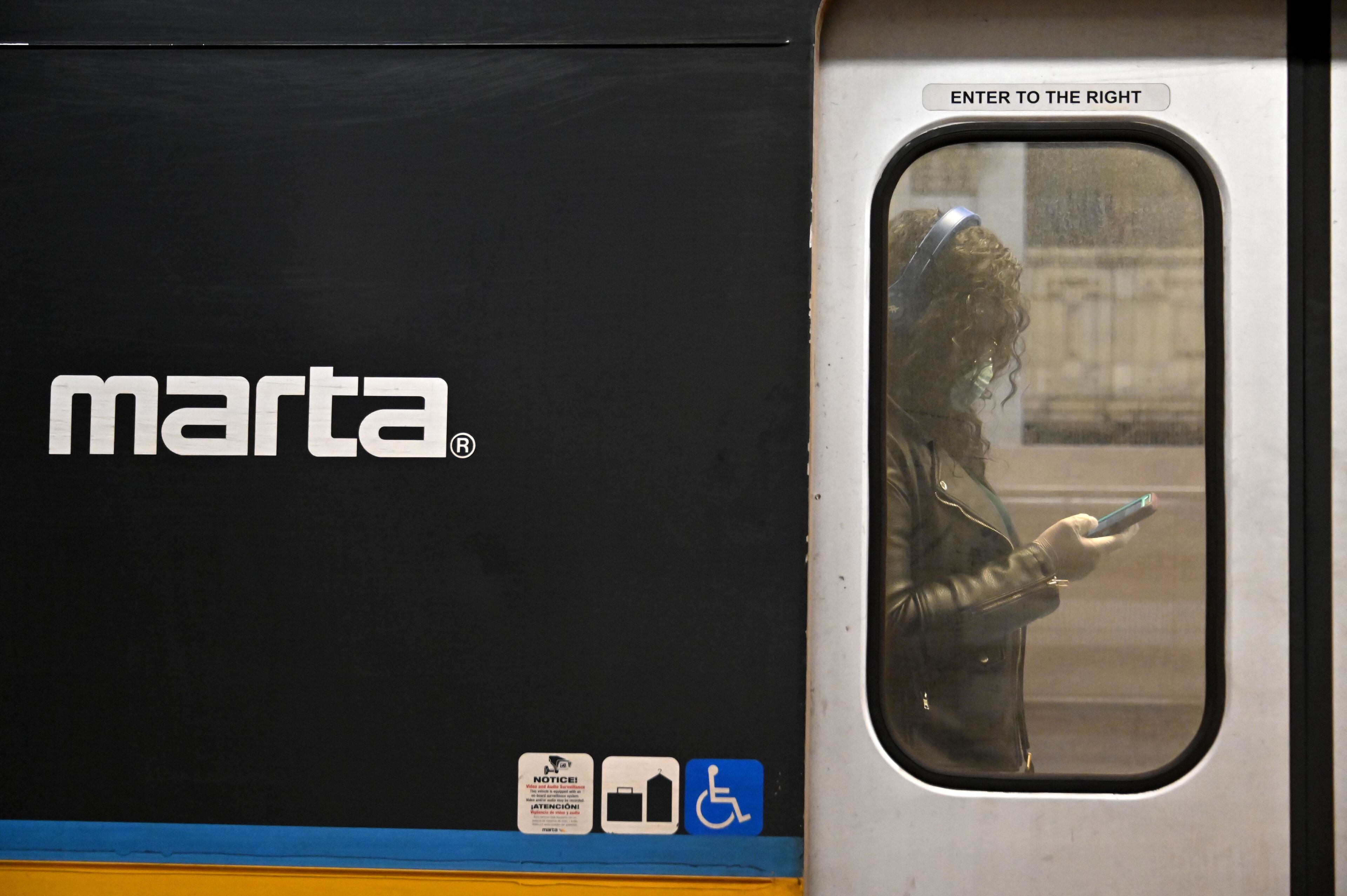 March12, 2020 Atlanta - A Marta customer wearing a mask stands inside a train during an afternoon rush hour at the Five Points MARTA station on Thursday, March 11, 2020. (Hyosub Shin / Hyosub.Shin@ajc.com)