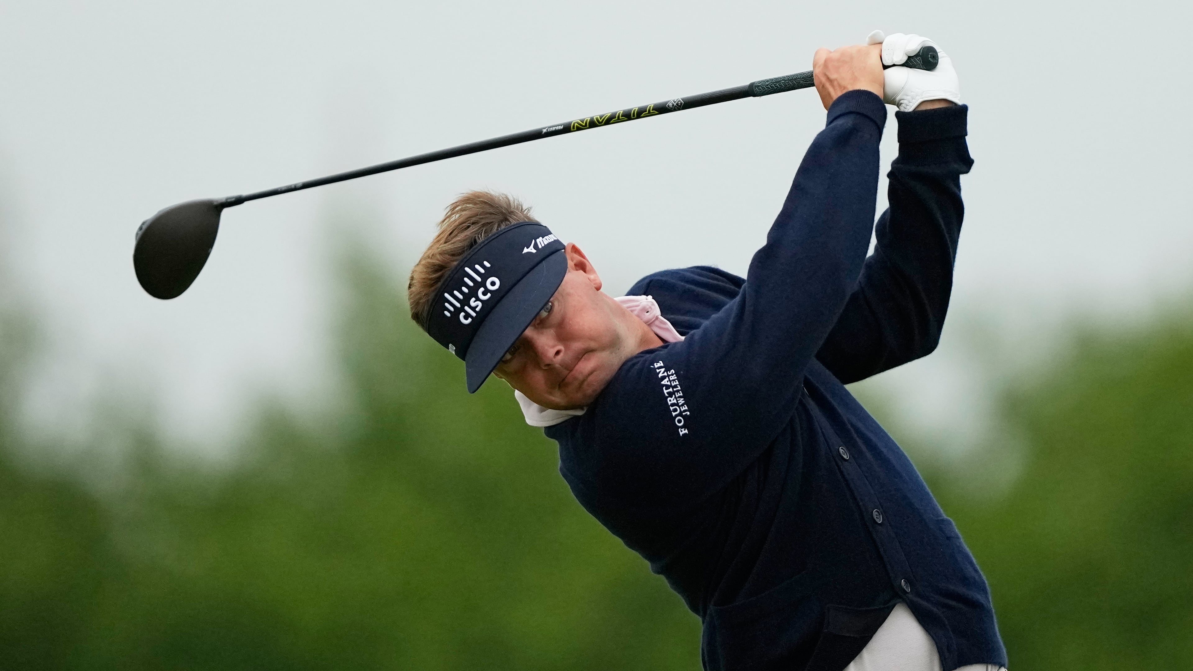 Keith Mitchell watches his tee shot on the 13th hole during the first round of the U.S. Open golf tournament at Shinnecock Hills Golf Club in Southampton, N.Y., Thursday, June 18, 2026.(AP Photo/Gerald Herbert)