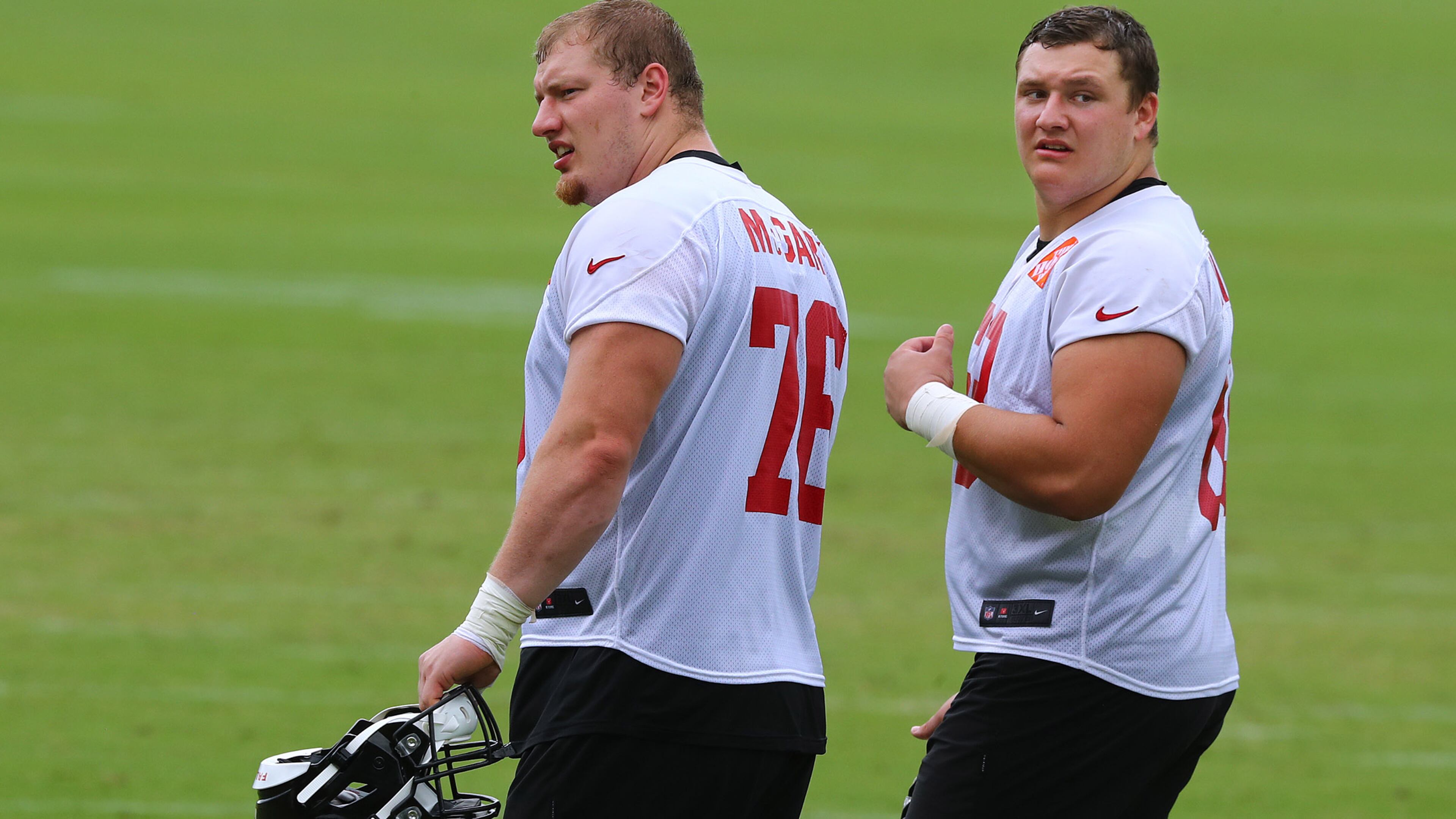 Falcons first-round draft picks Kaleb McGary (left) and Chris Lindstrom walk off the field after practice during minicamp on Wednesday, June 12, 2019, in Flowery Branch.