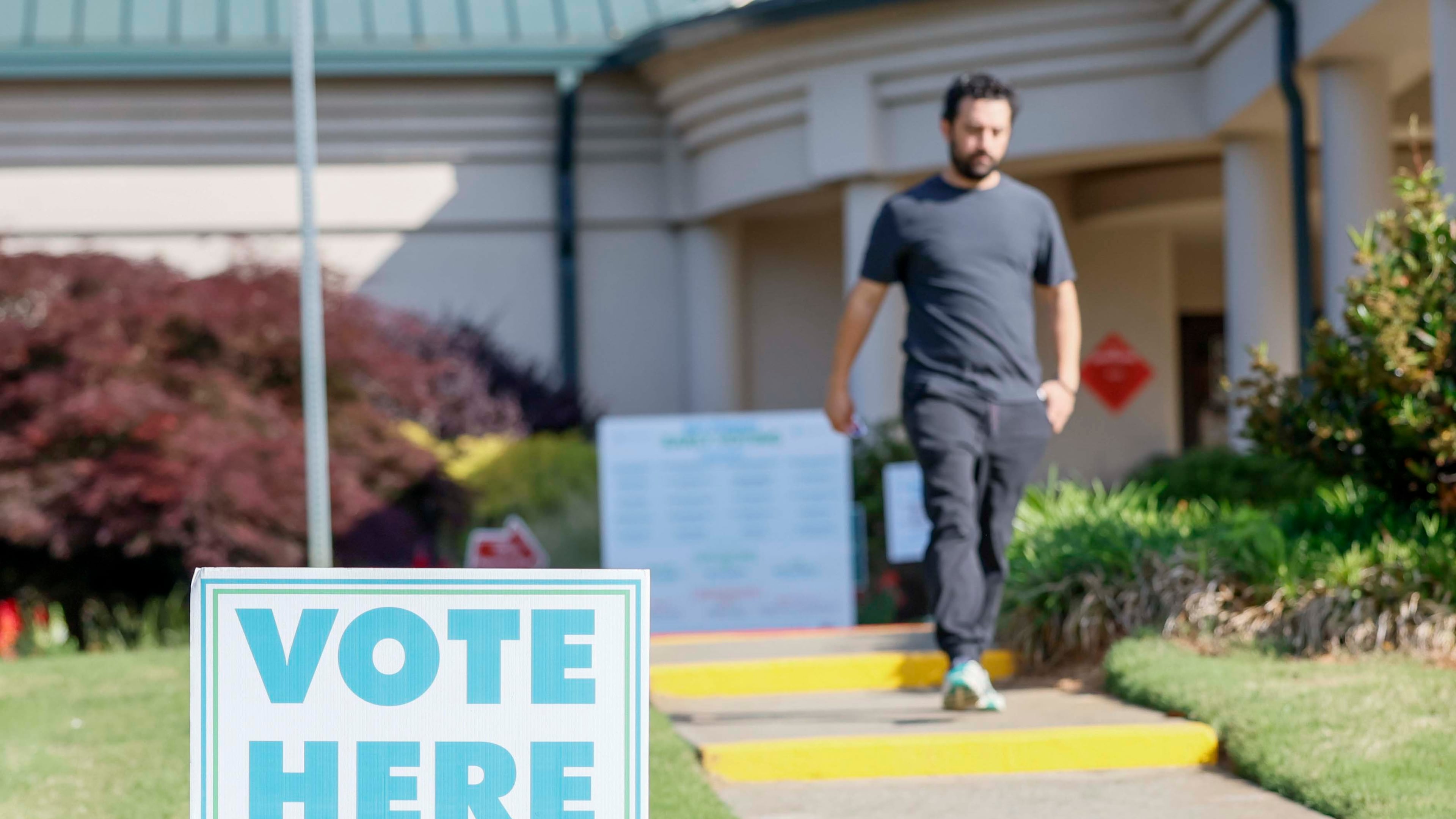 A man walks past a voting sign during the first day of early voting for the primary elections at the Dunwoody Library on Monday, April 27, 2026. (Miguel Martinez/AJC)