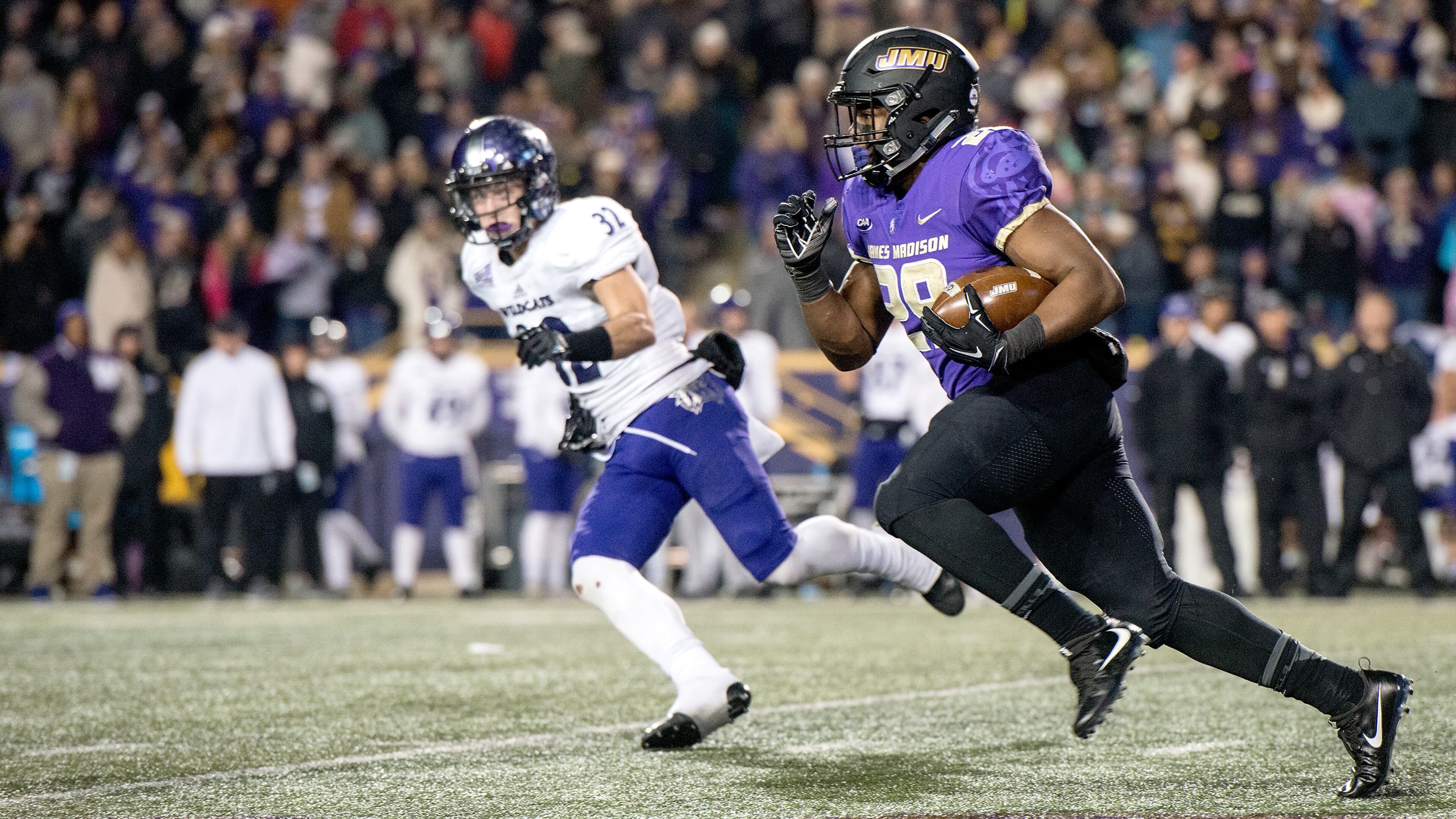 (12/8/17) - (Harrisonburg)James Madison Dukes running back Marcus Marshall (29) runs past the Weber State defense during the third quarter of the JMU vs. Weber State FCS Quarterfinals Friday night.(Stephen Swofford / DN-R)