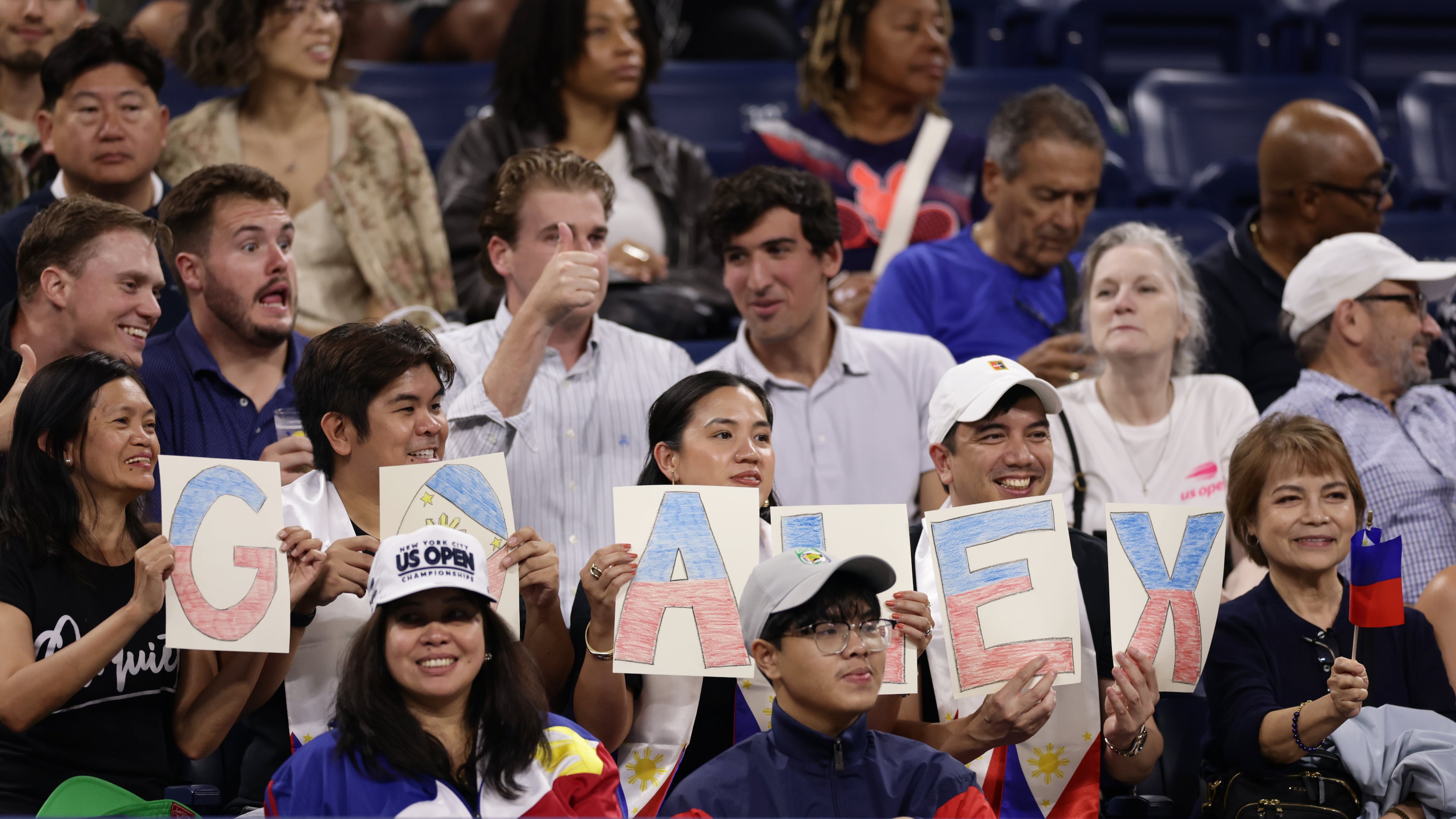 Fans of Alexandra Eala, of the Philippines, spell out "GO ALEX" with letters before her match against Mary Stoiana, of the United States, in the first round of the U.S. Open tennis championships Tuesday, Sept. 1, 2026, in New York. (AP Photo/Adam Hunger)