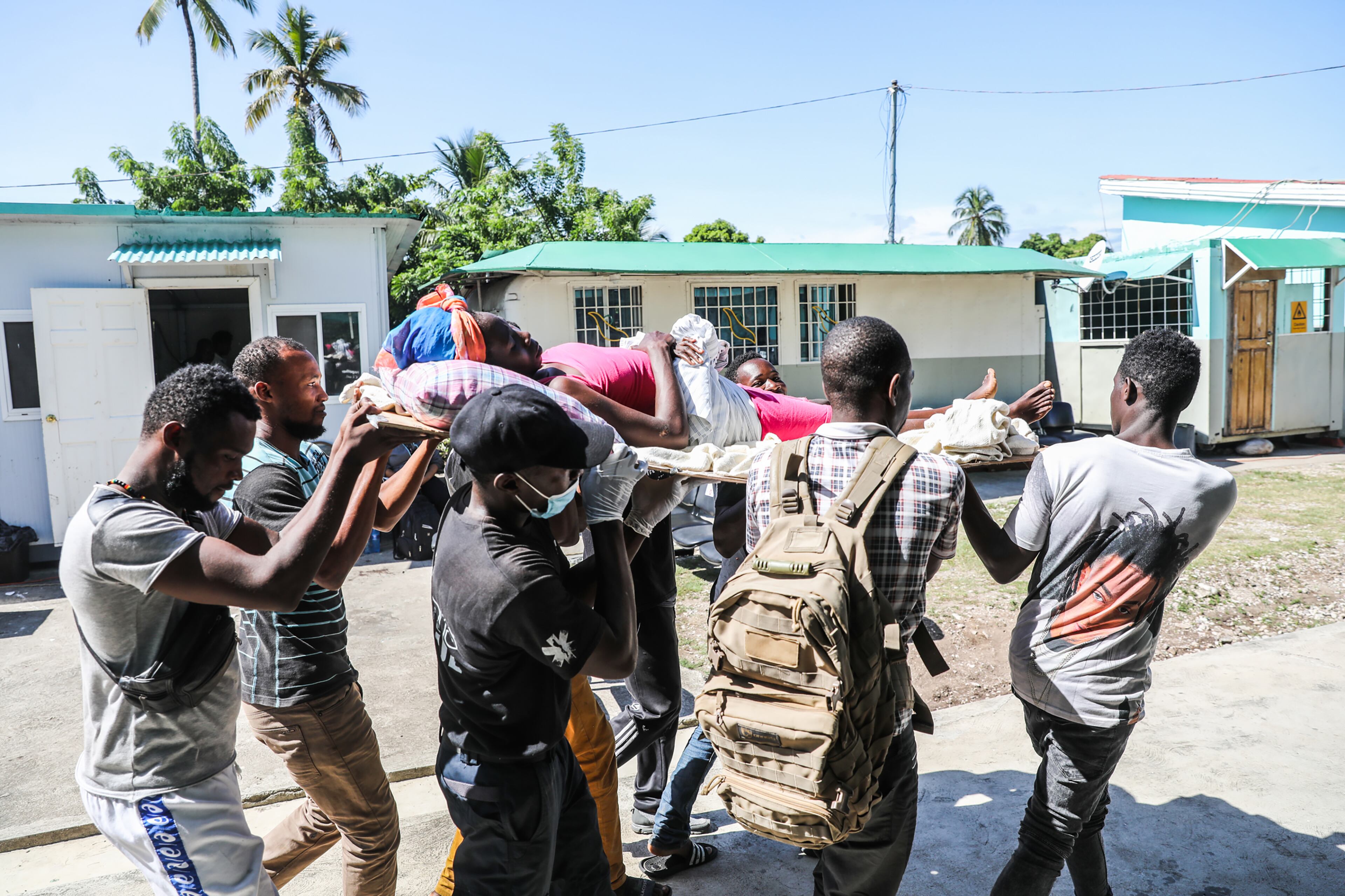 A woman wounded in an earthquake is carried on a stretcher at Cayes Airport to be transported to Port-au-Prince, Haiti, on Sunday, Aug, 15, 2021. Haitians struggled with a lack of basic supplies, including food and medical care, in the aftermath of a magnitude 7.2 earthquake on Saturday that snapped water lines, blocked roaCayes Airportds, flattened grocery stores and damaged hospitals on the country’s southwestern peninsula. (Valerie Baeriswyl/The New York Times)
