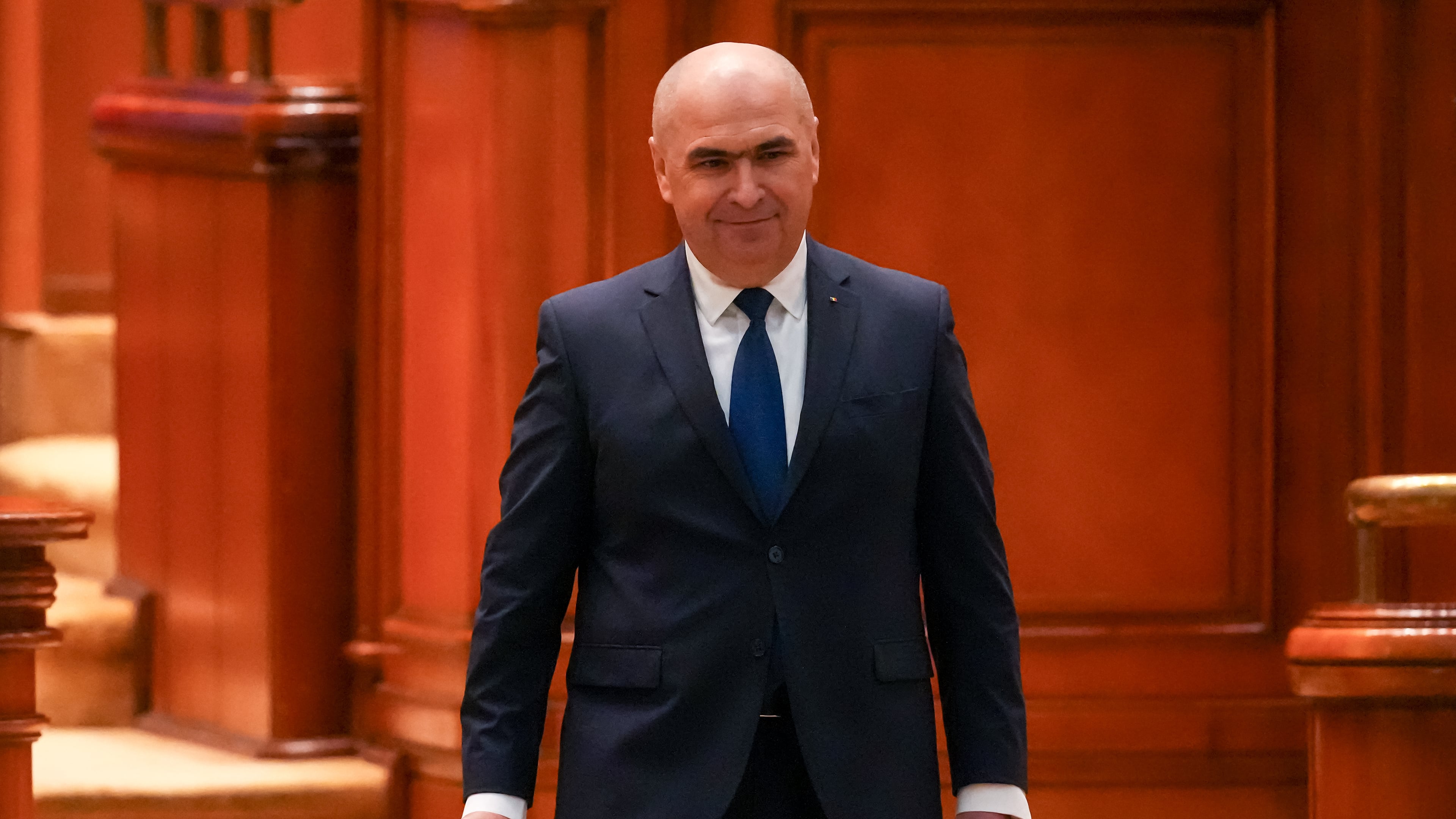 Romanian Prime Minister Ilie Bolojan arrives at a parliament session ahead of a no confidence vote in Bucharest, Romania, Tuesday, May 5, 2026. (AP Photo/Vadim Ghirda)