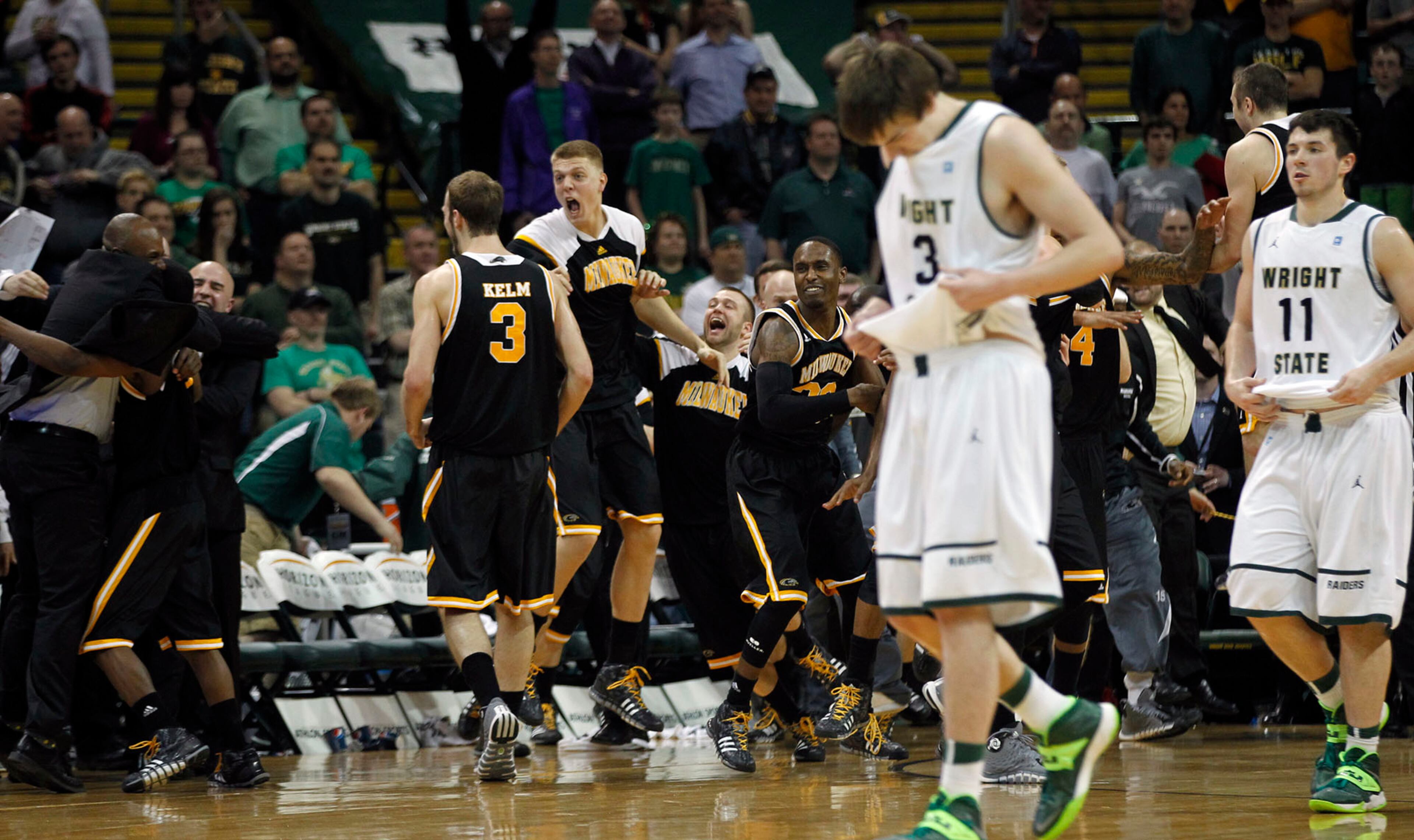 Milwaukee Panthers react as the clock ran out to defeat the Wright State Raiders 69-63 for the Horizon League Championship. Raiders Reggie Arceneaux and JT Yoho head for the locker room. TY GREENLEES / STAFF