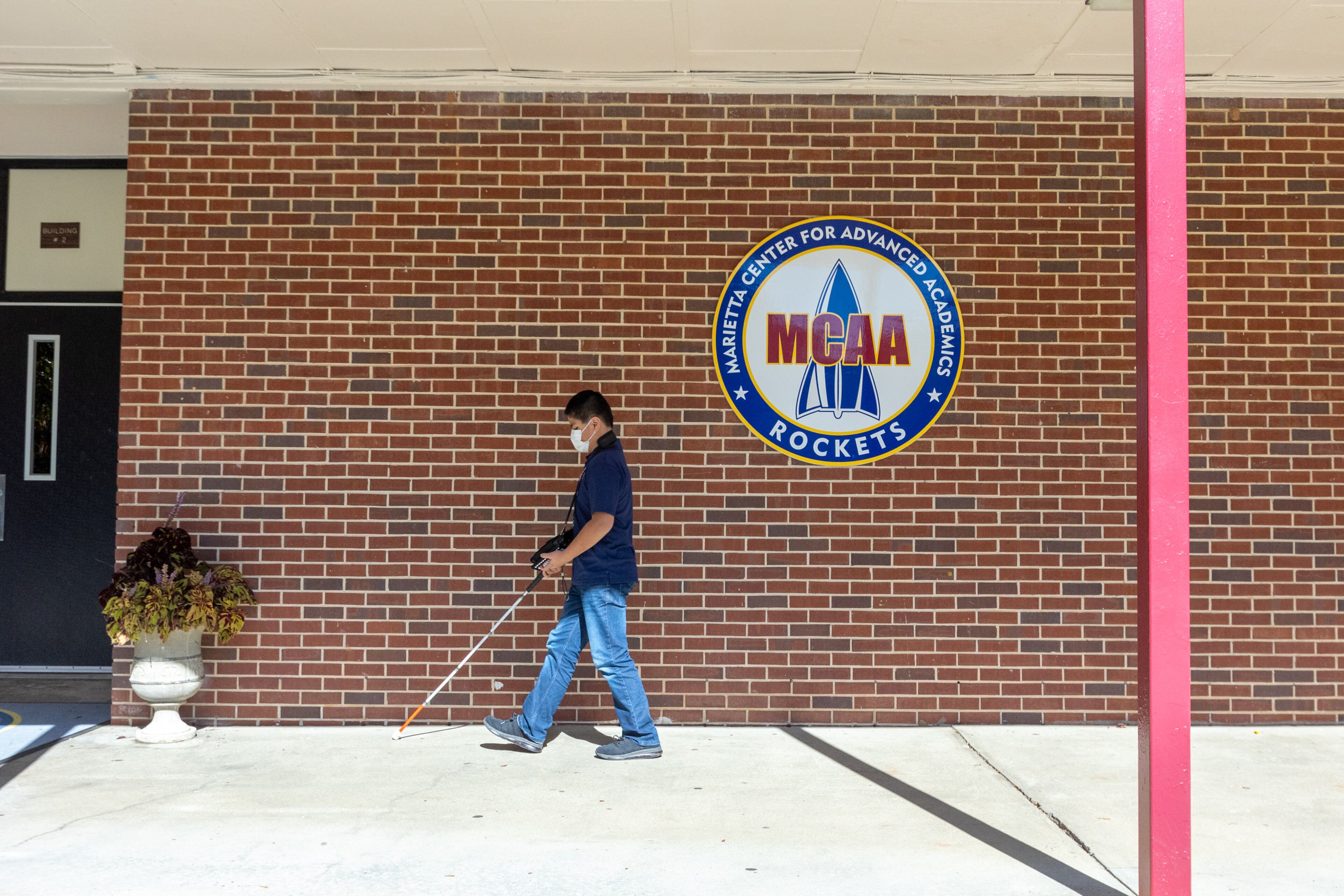 George Eaker, 12, a fifth grader at Marietta Center for Advanced Academics, returns to class after working one-on-one with special education teacher Tracy Fitch. She teaches him to read and write in Braille, to do math on an abacus and "incidental" skills needed as a blind student Tuesday, Nov 9, 2021. (Jenni Girtman for The Atlanta Journal-Constitution)