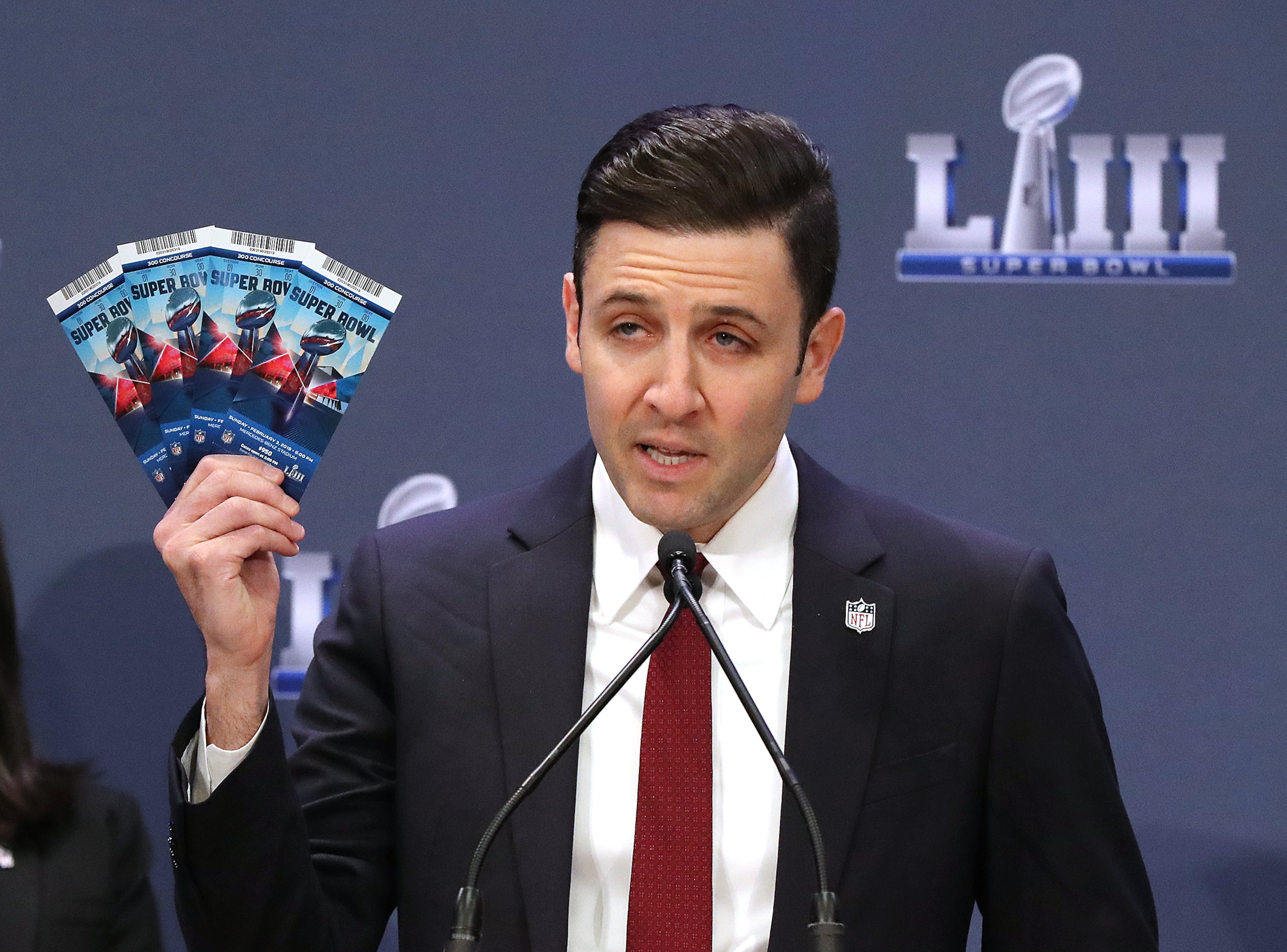 Michael Buchwald, NFL Senior Counsel, Legal, holds up real Super Bowl tickets during the National Football League and law enforcement agencies press conference announcing the latest results of seizures of counterfeit game-related merchandise and tickets during a press conference at the Georgia World Congress Center on Thursday, Jan. 31, 2019, in Atlanta. Curtis Compton/ccompton@ajc.com
