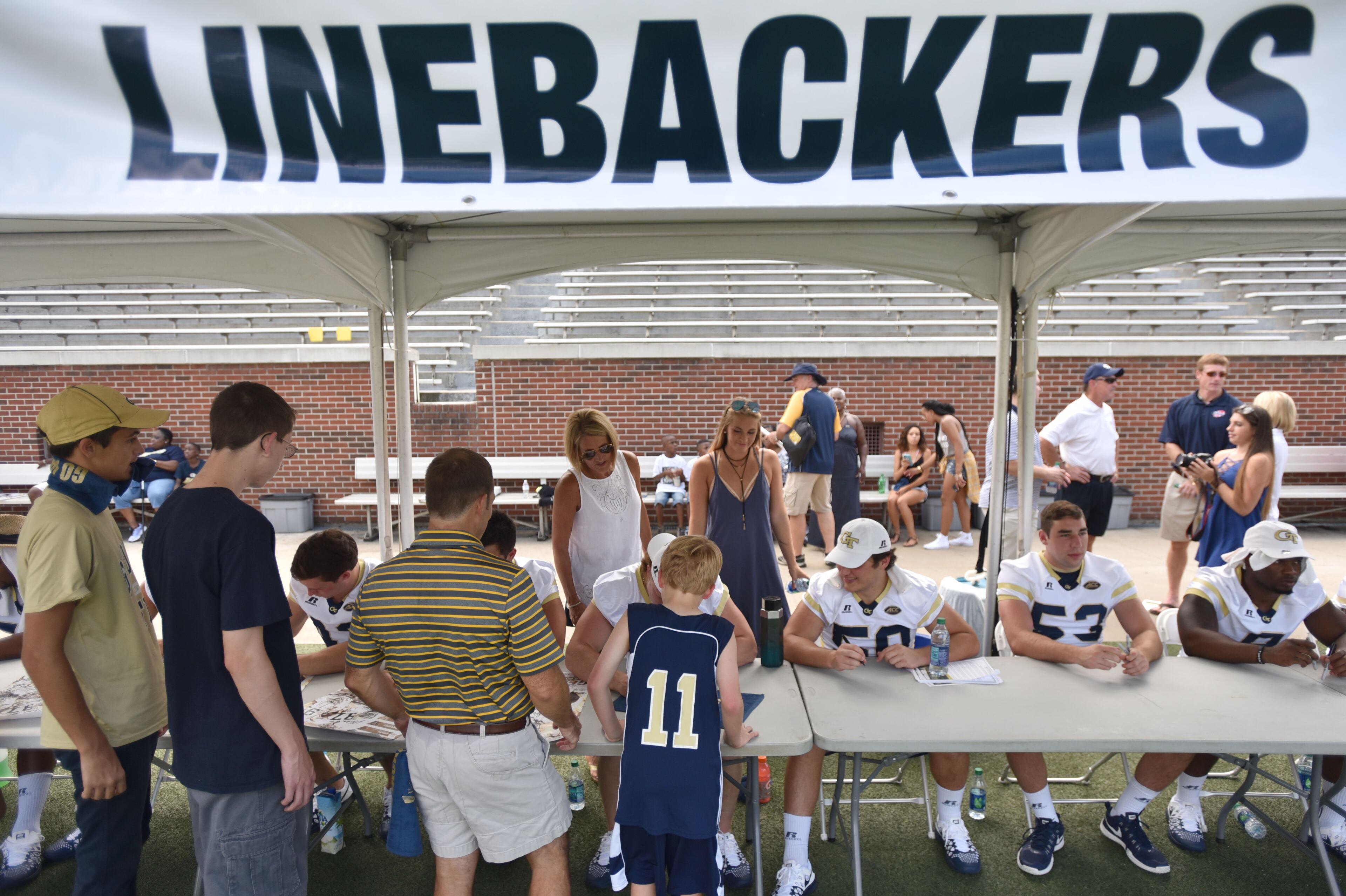 Georgia Tech Yellow Jackets linebackers sign autographs for fans during 2016 Football Fan Day at Bobby Dodd Stadium on Saturday, August 6, 2016. HYOSUB SHIN / HSHIN@AJC.COM