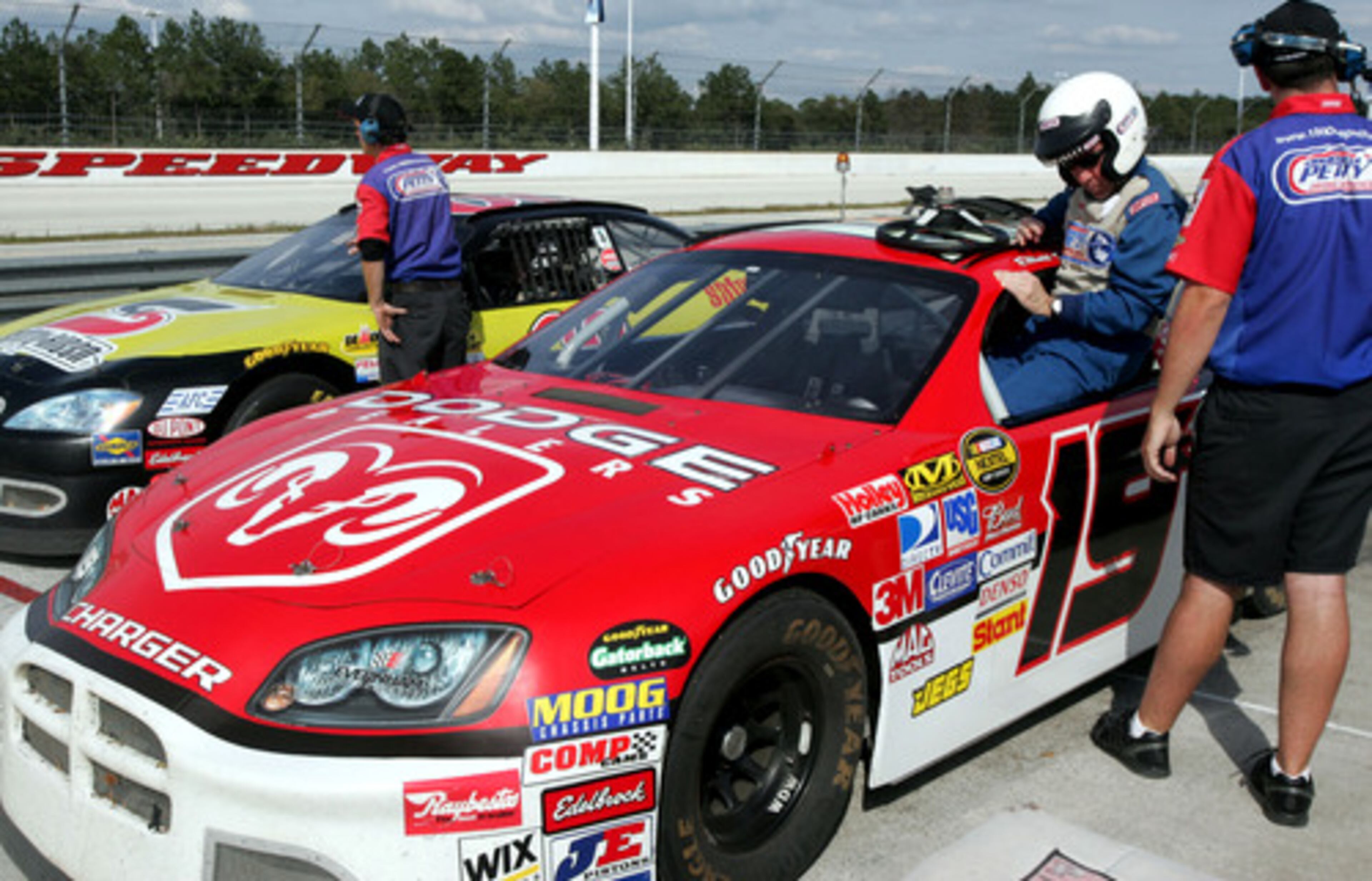 AJC reporter Clint Williams climbs in to a race car at the Richard Petty Driving Experience at the Walt Disney World Speedway. For a few weeks each year, Walt Disney's Magic Kingdom becomes the Manly Kingdom, a place to watch Braves baseball up close. When the Braves hit the road for the day, you can learn to drive a NASCAR race car.