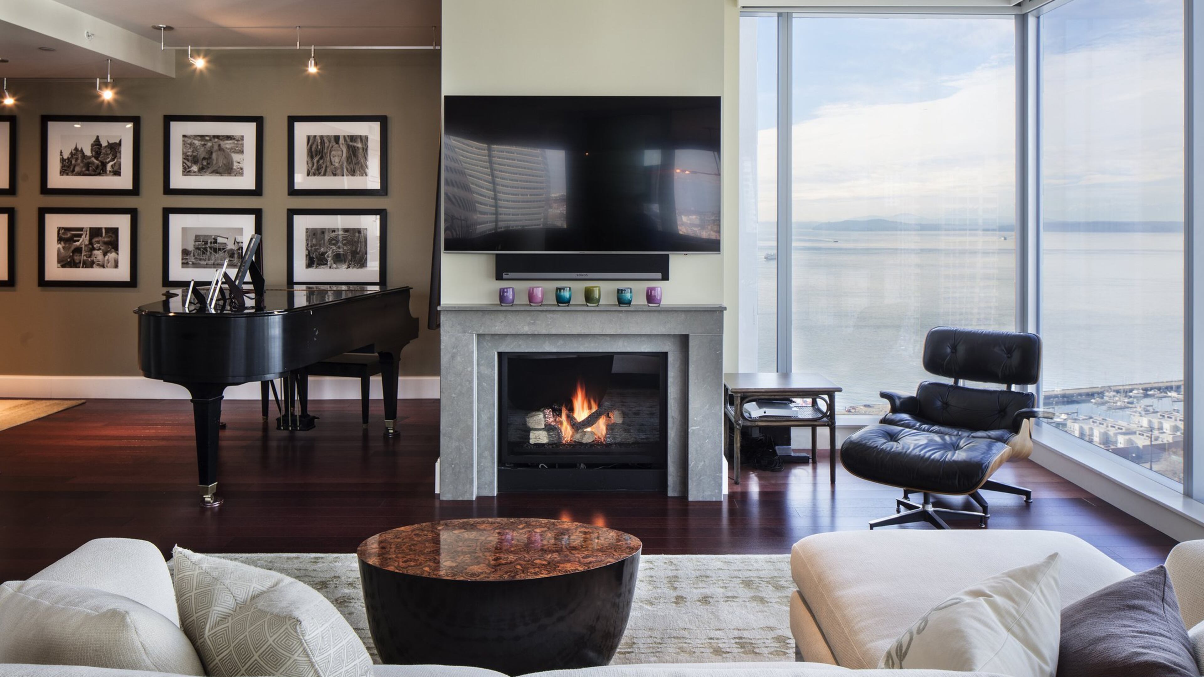 John and Jan Drinkard brought the Eames lounge chair, the stately grand piano and John s black-and-white photographs to the dcor of their downtown condominium s living room and entryway, where interior designer Lindsey Runyon used Benjamin Moore s Providence Olive paint for the accent wall. The custom Tibetan runner at left is by Lapchi, from Driscoll Robbins Fine Carpets. The wool in the rug is hand-carded and hand-woven with silk, and the rug is RugMark-certified, she says. The paint we did after the rugs; that s my system. (Steve Ringman/Seattle Times/TNS)