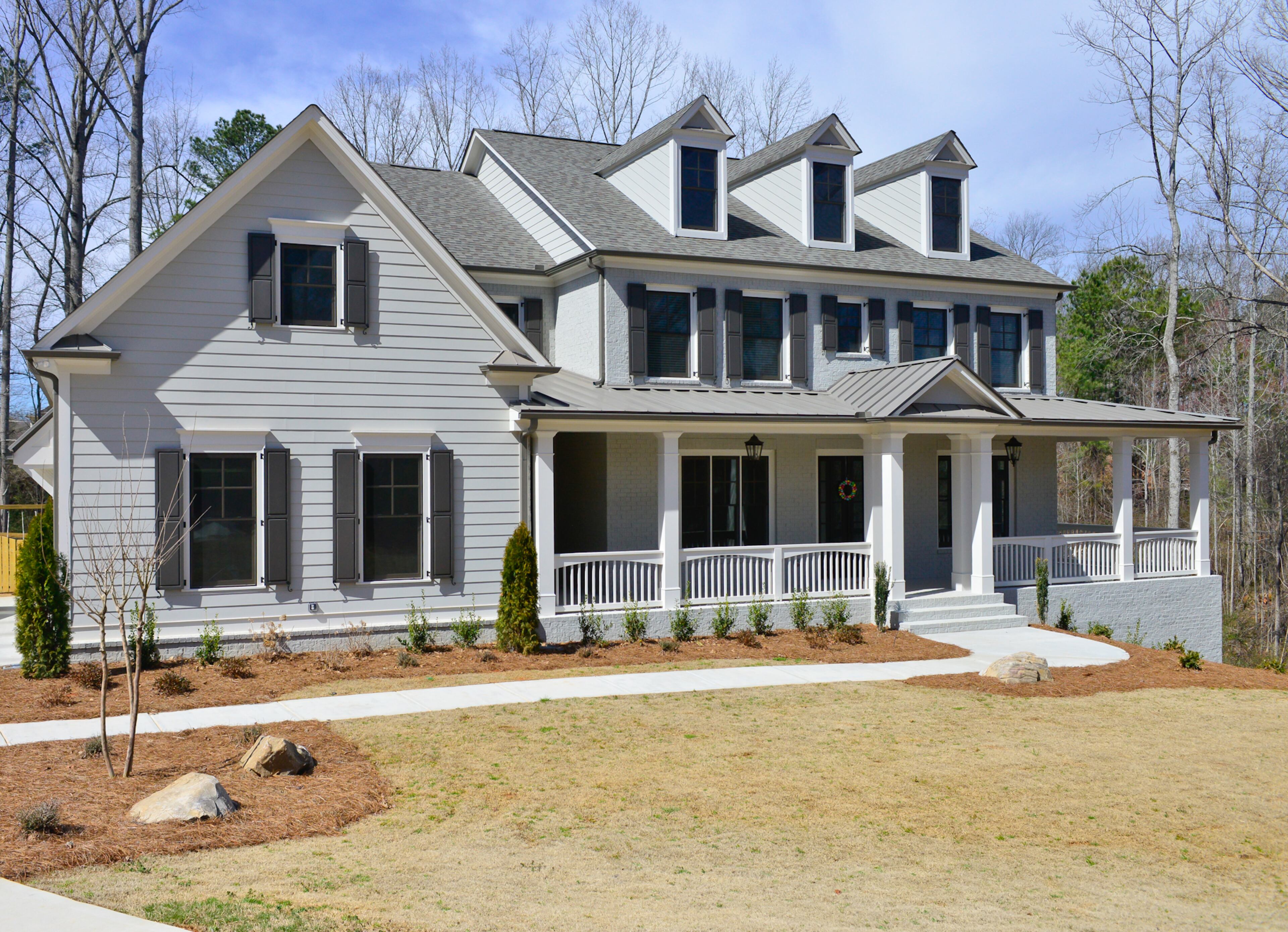 Justin and Sophia DeCouto's five-bedroom, four-bath home in Milton's Lake Haven of Crabapple neighborhood is painted in Sherwin Williams Mindful Gray, including the exposed brick, with Aesthetic White trim and Black Fox shutters. -- Text by Lori Johnston