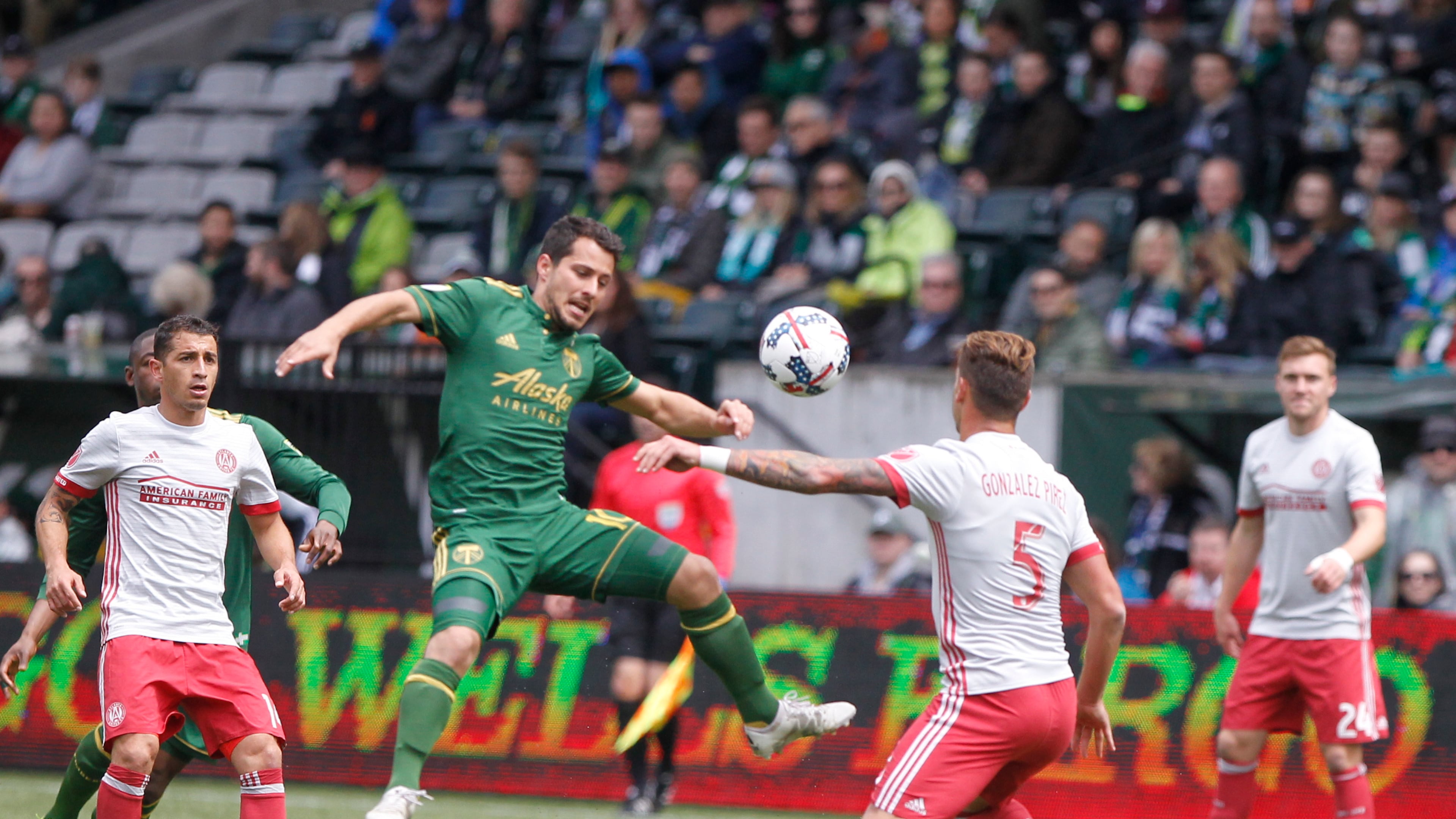 Portland's Sebastian Blanco, center, tries to corral the ball as Atlanata's Leandro Gonz'lez Pirez (5) defends as the Portland Timbers hosted Atlanta United FC in a MLS match at in Portland, Ore., Sunday, May 14, 2017. (Sean Meagher/The Oregonian via AP)