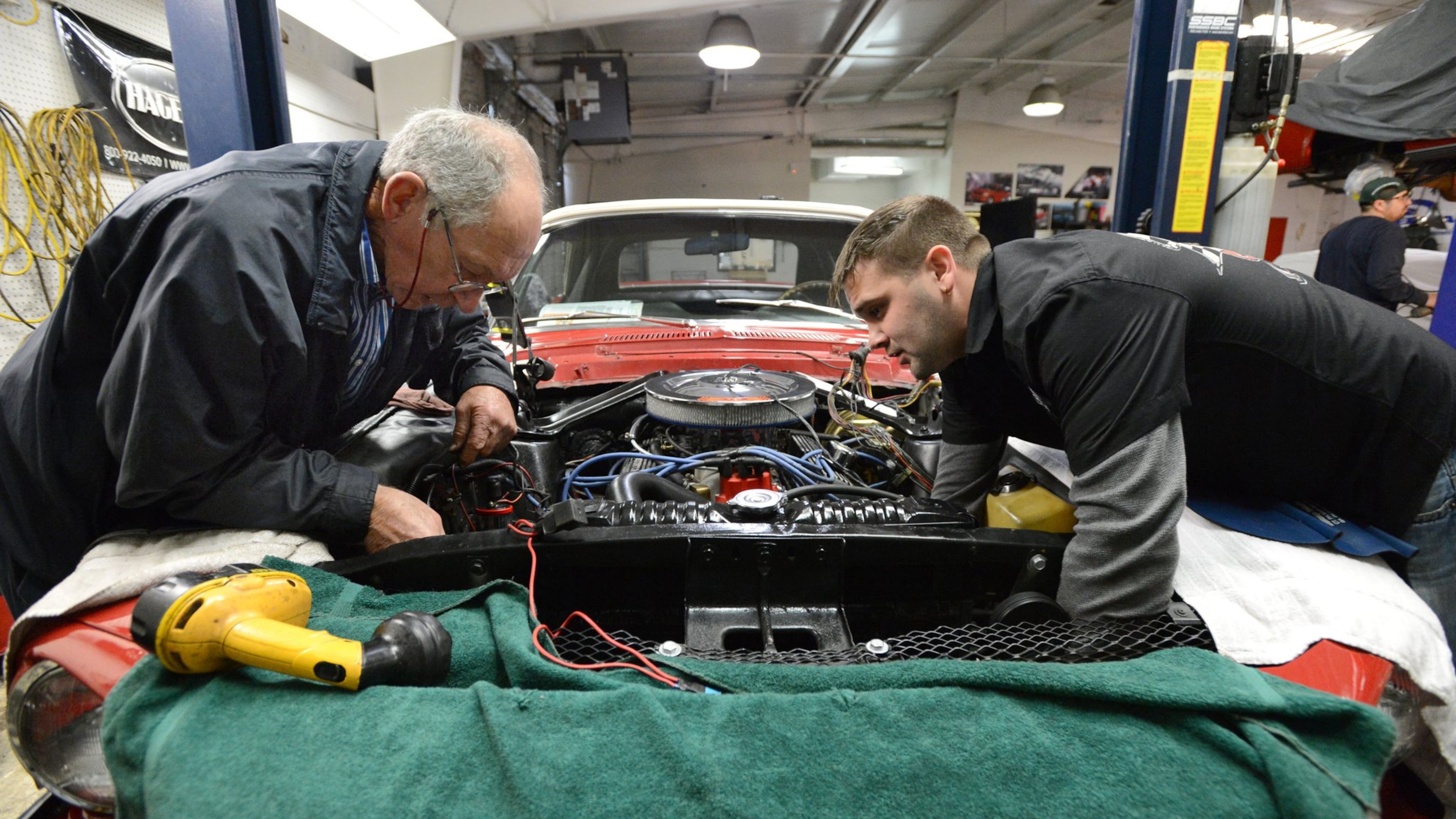 Mechanic Hutch Hall (left) and Chris Trusty, manager, restore a 1968 Ford Shelby Mustang at Fraser Dante Ltd. in Roswell, which specializes in the restoration and repair of vintage cars. HYOSUB SHIN / HSHIN@AJC.COM