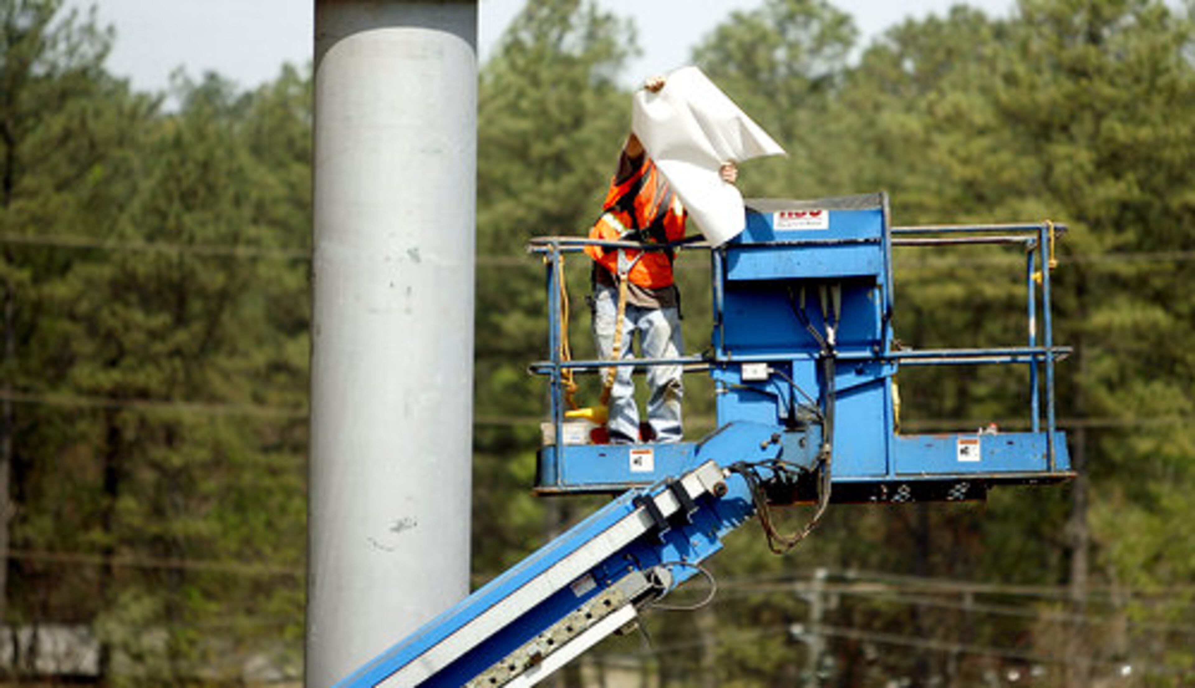 Boomer Balmert inspects the fabric used for the roof of the amphitheatre.