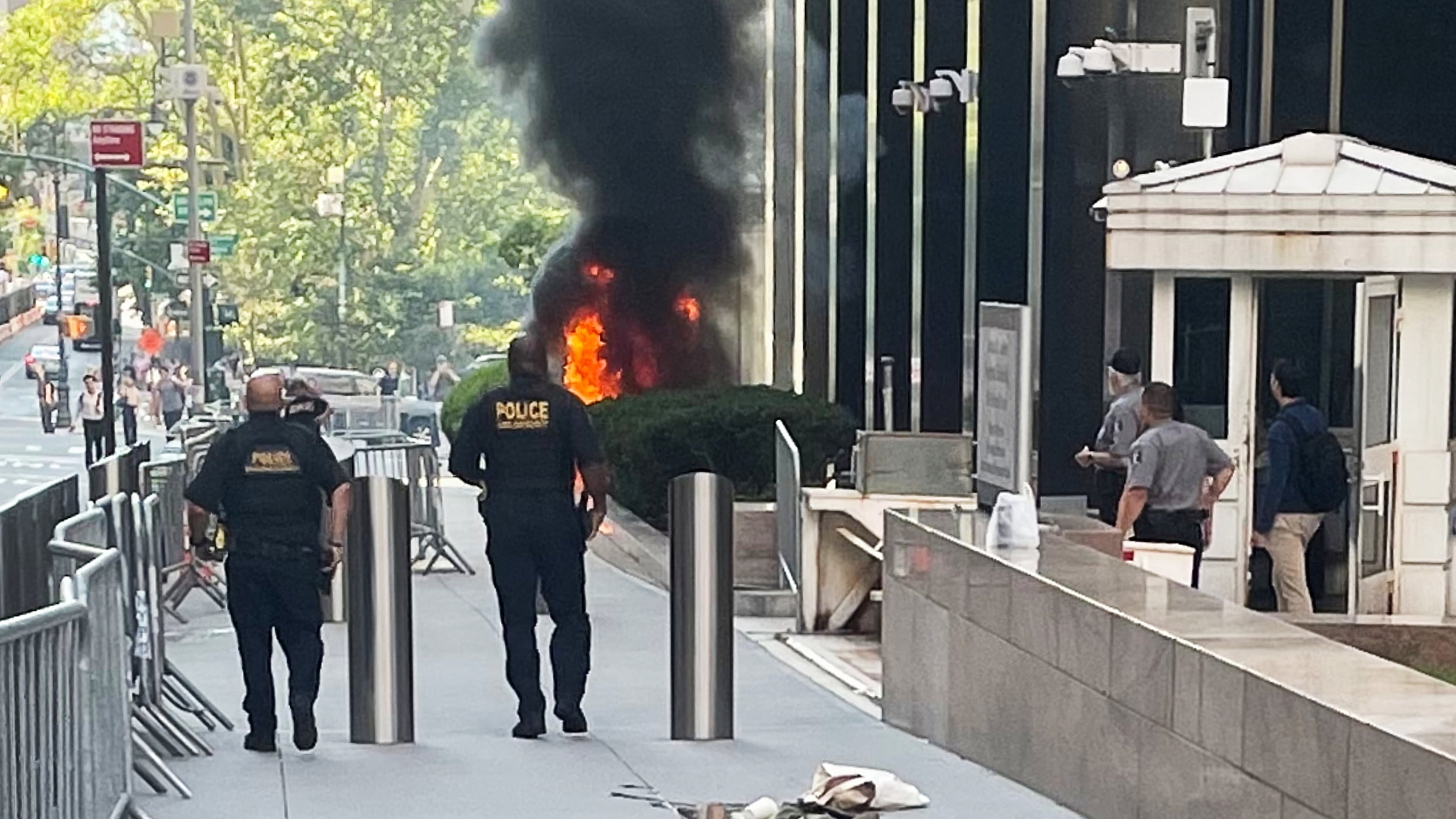 This photo provided by Robert Sullivan shows black smoke and flames in front of 26 Federal Plaza in lower Manhattan, Monday, July 20, 2026, in New York. (Robert Sullivan via AP)