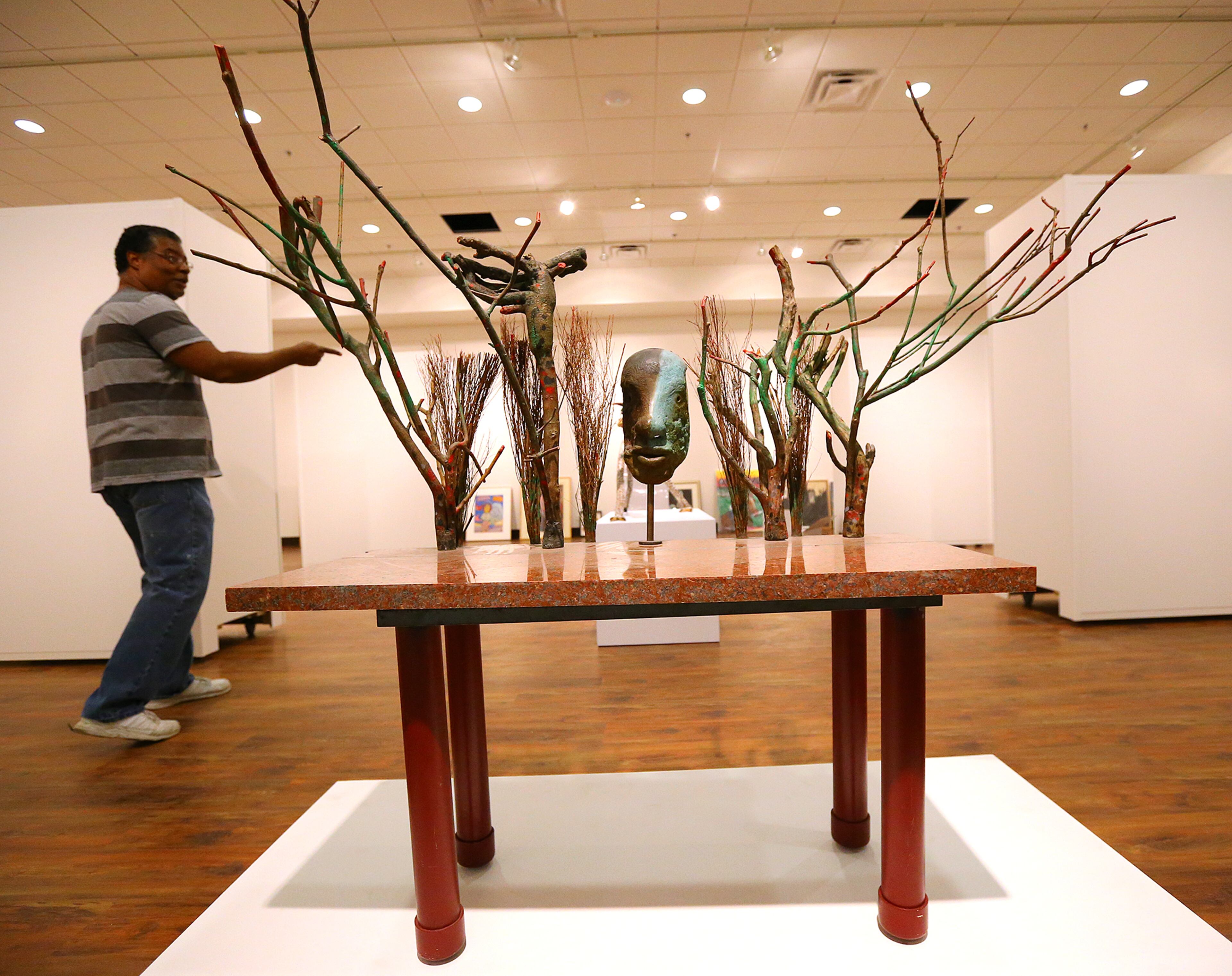 Jeffrey Bruce, curator at the Tubman Museum, passes a piece by Donald Lock titled “Table For Dunnamite Dan,” during a tour of the Tubman Museum of African American Art, History and Culture on Wednesday, May 6, 2015, in Macon. Curtis Compton / ccompton@ajc.com