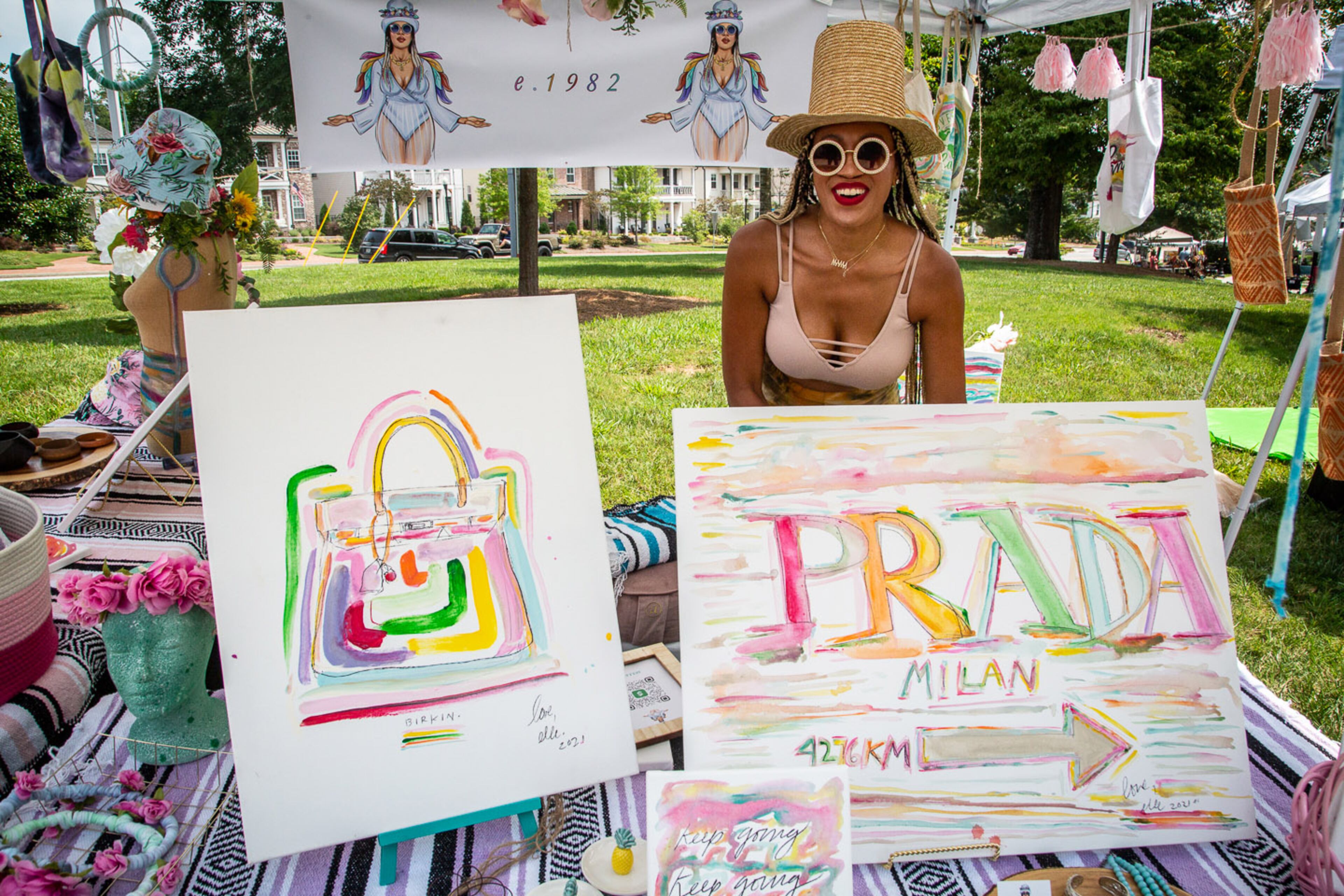 Elle Sawyer waits for customers during Art in the Park at Brooke Street Park in Alpharetta on Sunday, July 25, 2021. (Photo: Steve Schaefer for The Atlanta Journal-Constitution)