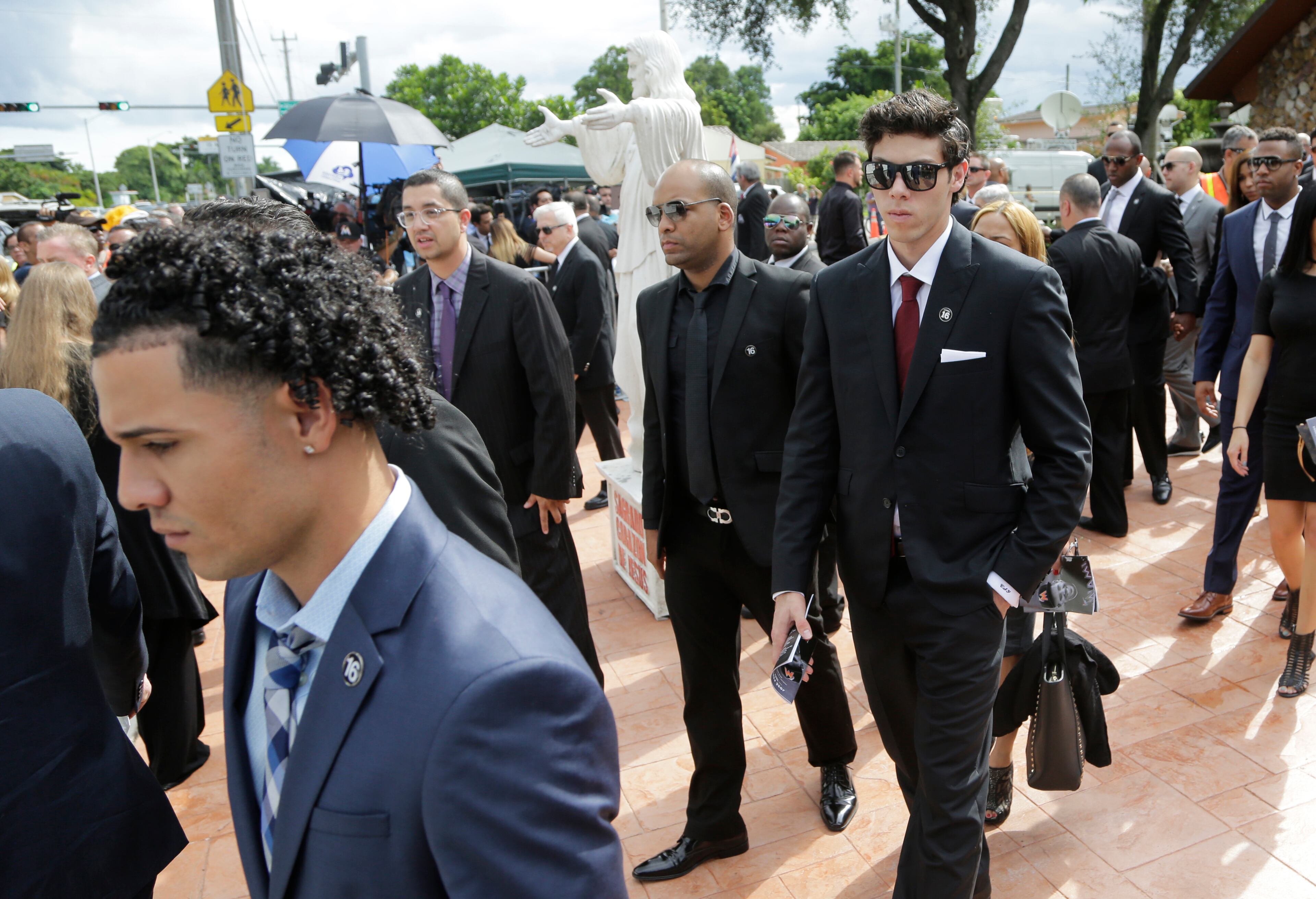 Miami Marlins left fielder Christian Yelich, right, leaves a memorial service for Miami Marlins pitcher Jose Fernandez, at St. Brendan's Catholic Church, Thursday, Sept. 29, 2016, in Miami. Fernandez was killed in a boating accident Sunday along with two friends. (AP Photo/Lynne Sladky)