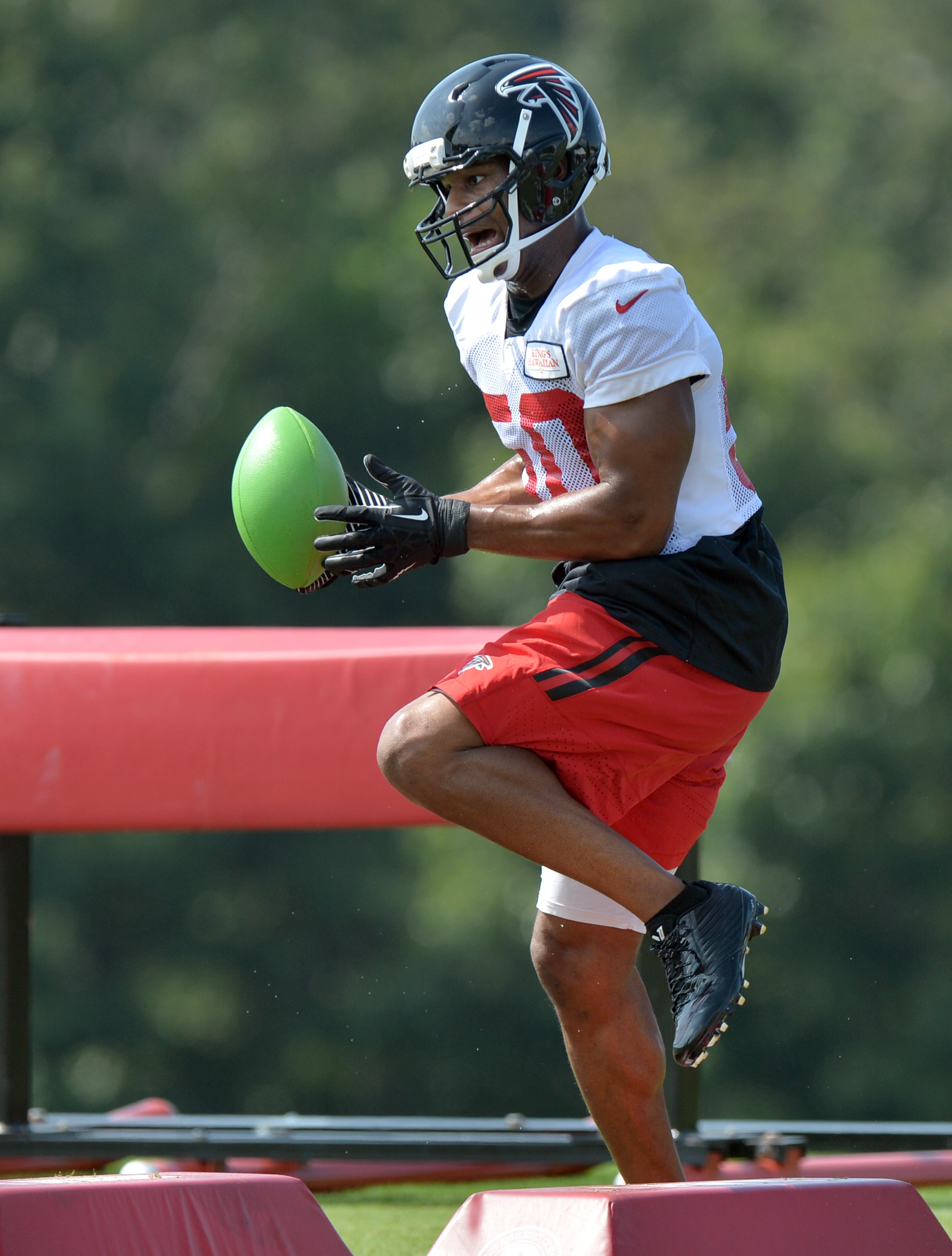 Atlanta Falcons defensive end Osi Umenyiora participates in a drill during training camp on Friday, July 25, 2014.