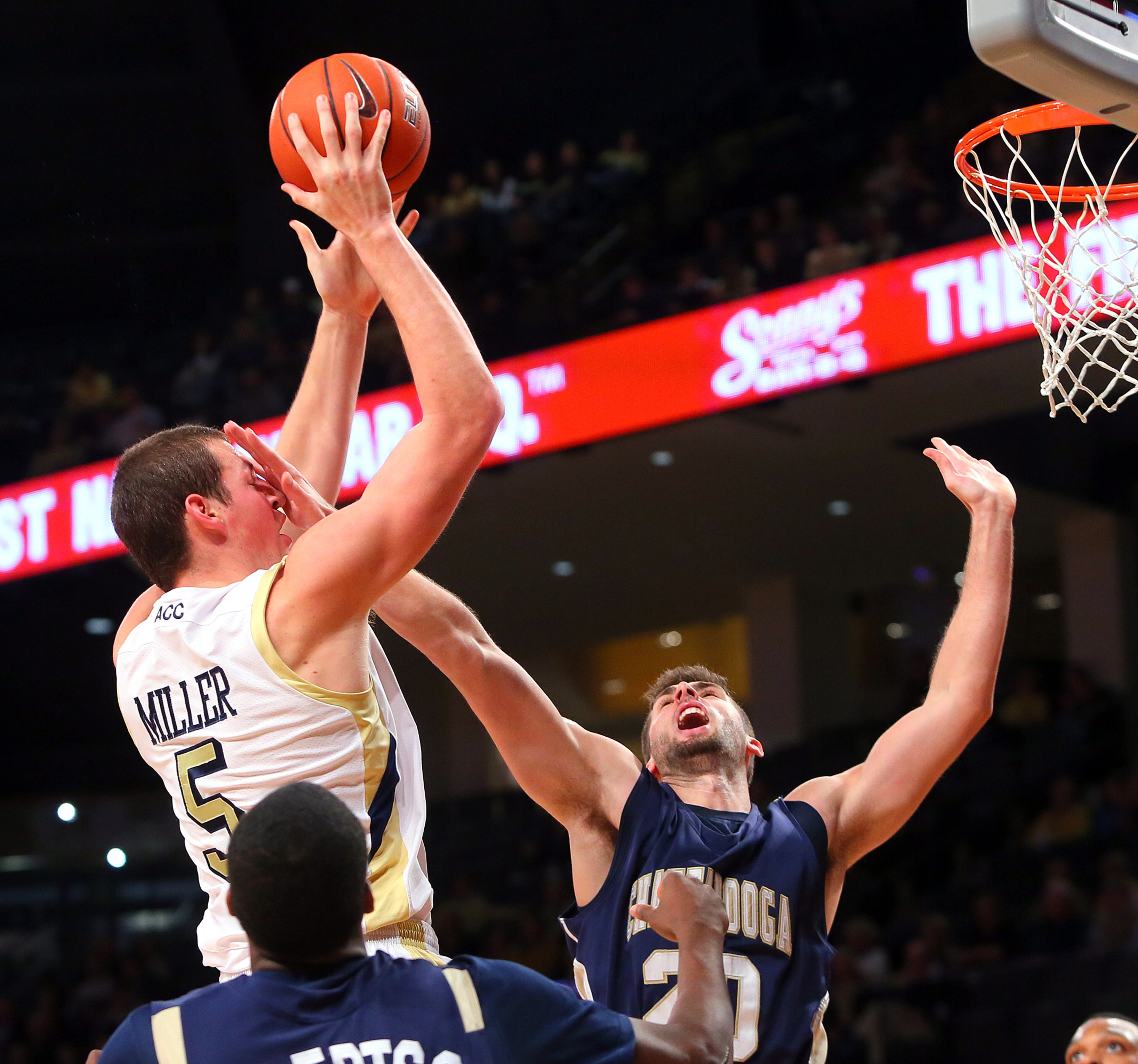 Georgia Tech center Daniel Miller takes a hand in the face while trying to get off a shot over Chattanooga Mocs forward Drazen Zlovaric during 1st half action at McCamish Pavilion in Atlanta on Wednesday, Jan. 2, 2013. CURTIS COMPTON / CCOMPTON@AJC.COM