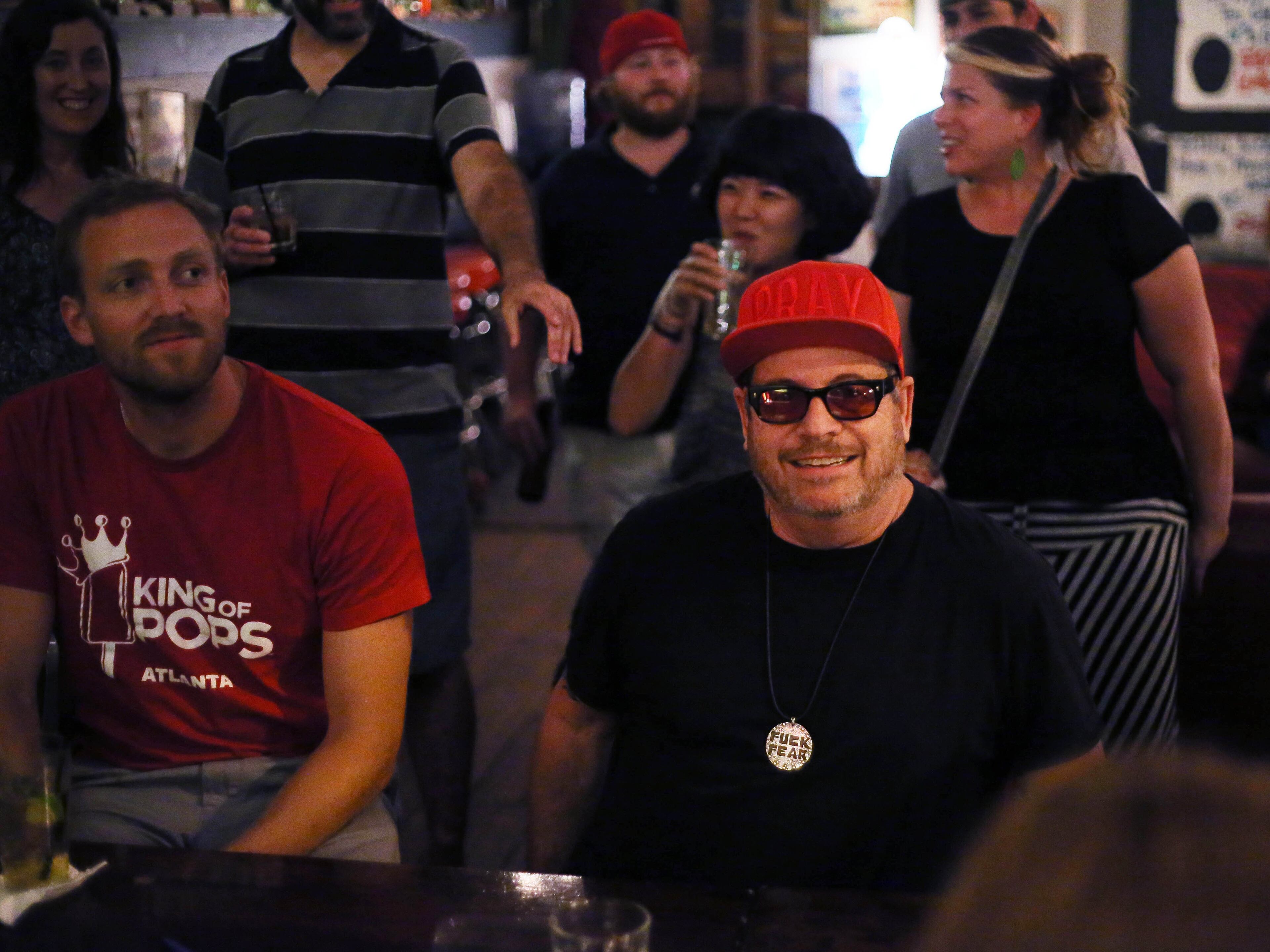 Grant Henry (right) and Steven Carse, who founded King of Pops watch the Monday night ping pong tournament. BOB ANDRES / BANDRES@AJC.COM