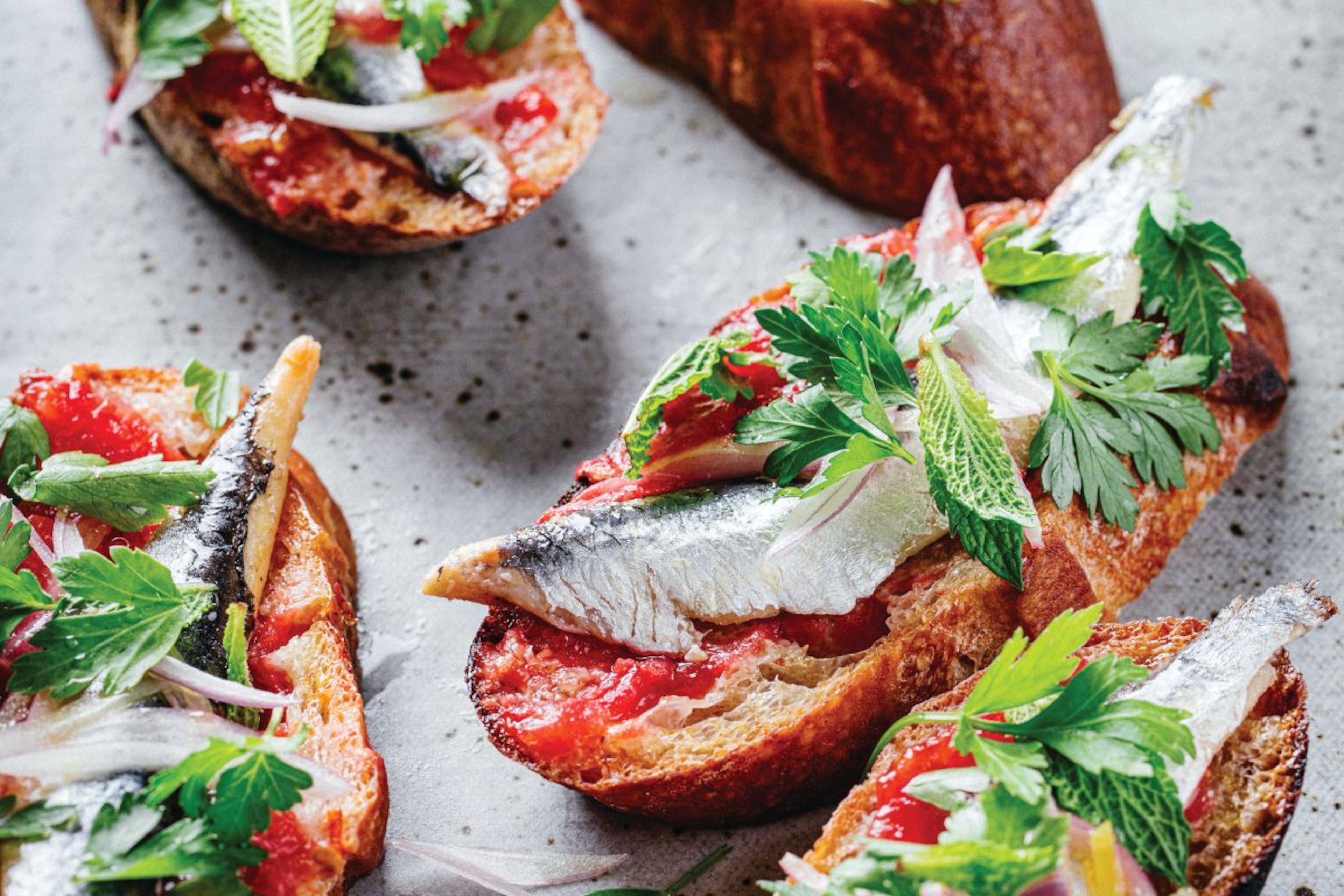 Andrew Zimmern's pan con tomate is a simple recipe that's perfect for early season tomatoes. (Courtesy of Eric Wolfinger)