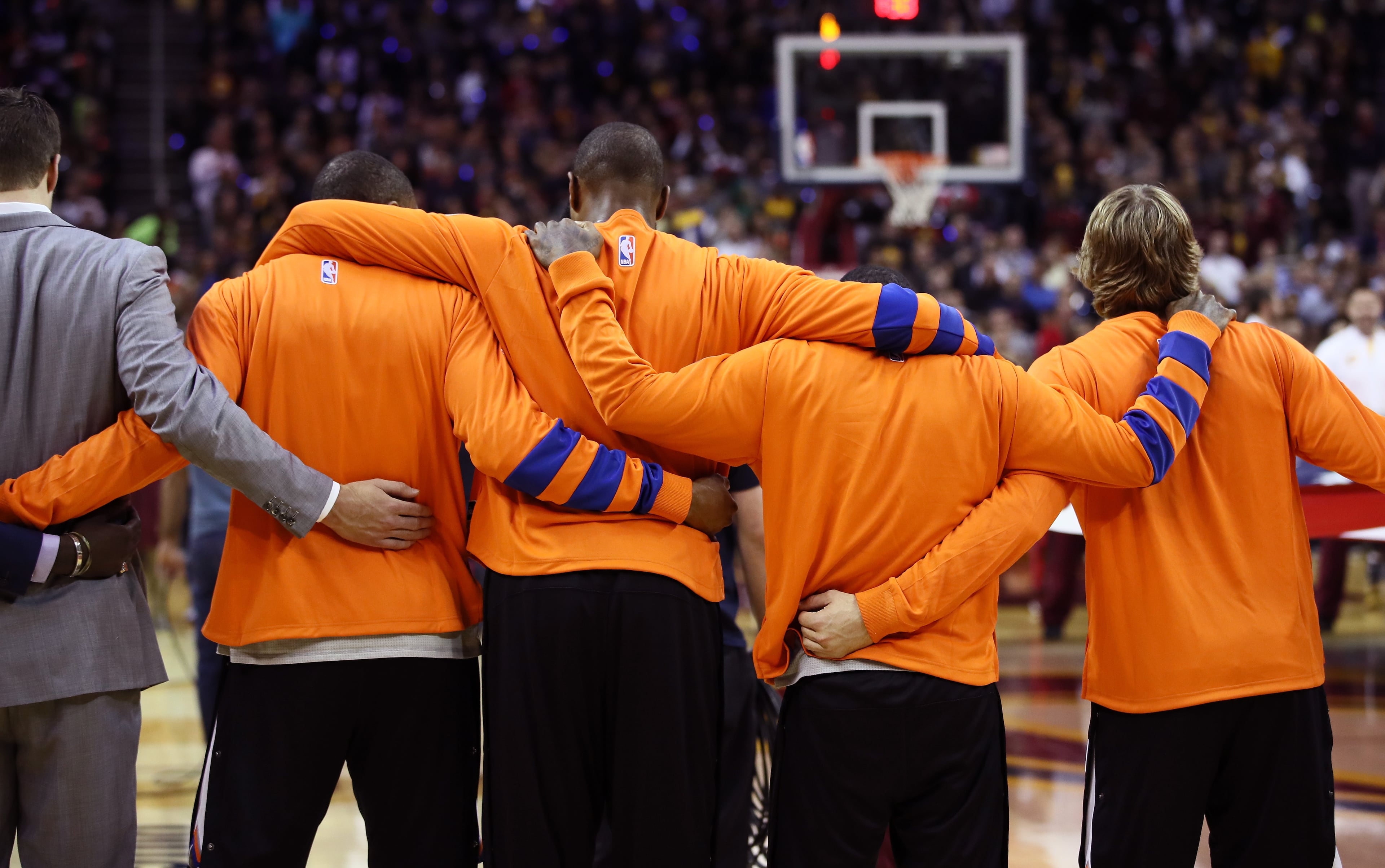 The New York Knicks embrace during the national anthem before the game against the Cleveland Cavaliers at Quicken Loans Arena on October 25, 2016 in Cleveland, Ohio. (Photo by Ezra Shaw/Getty Images)