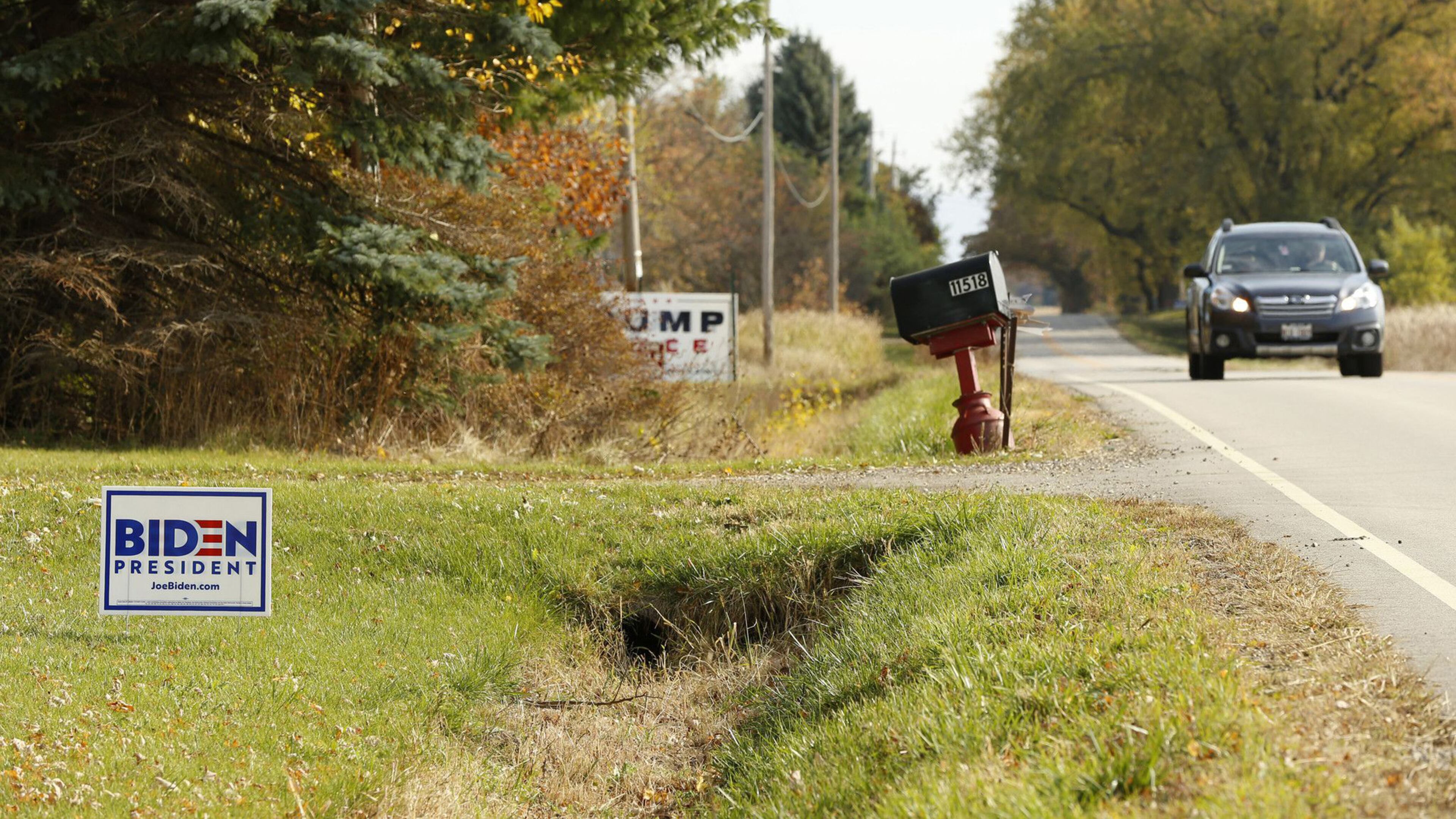 Neighboring Biden and Trump signs are shown along County Highway A in Somers, Wisconsin, on Oct. 21, 2020. (Stacey Wescott/Chicago Tribune/TNS)