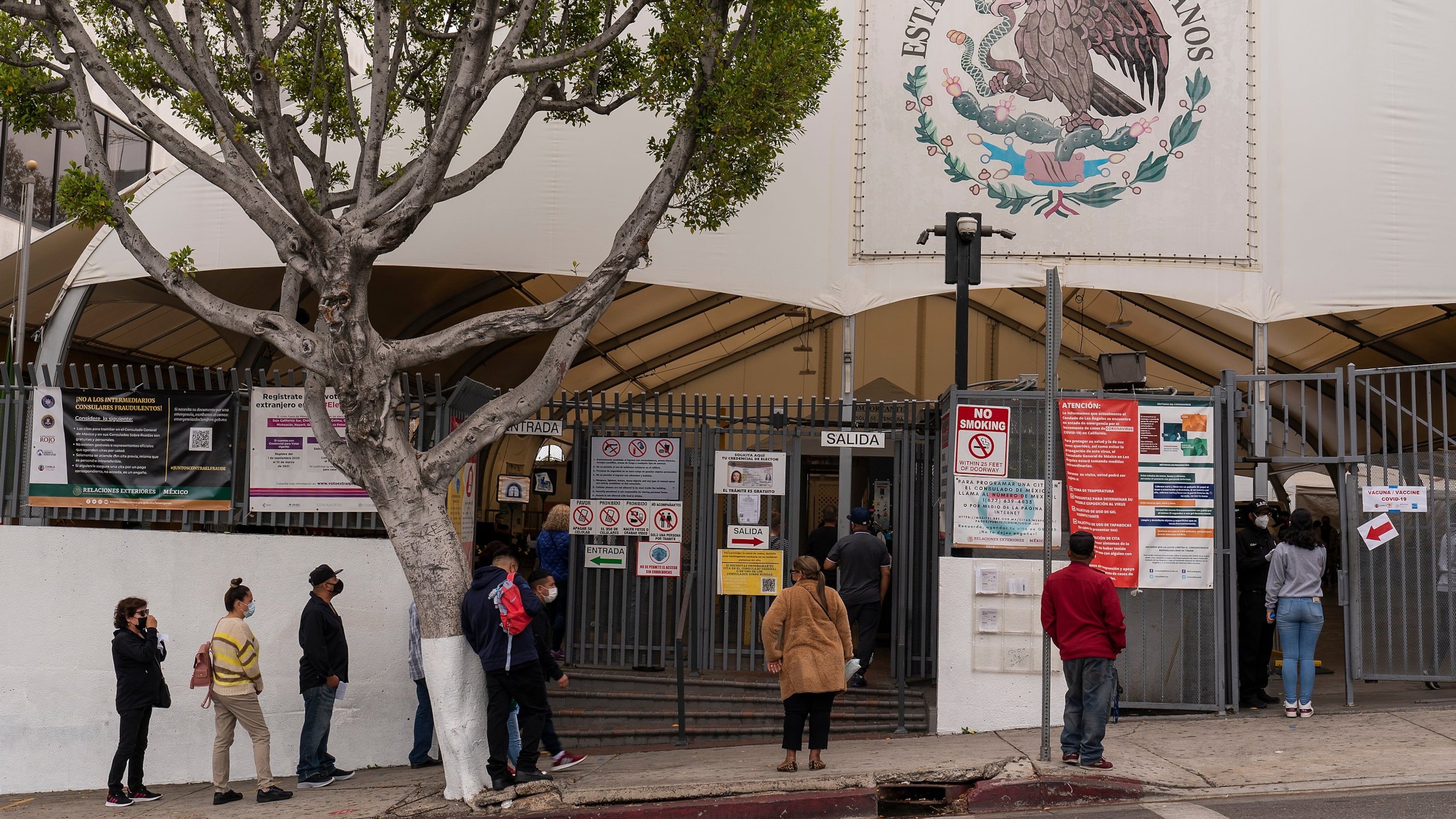 FILE - People line up for services at the Mexican Consulate in Los Angeles, May 8, 2021. (AP Photo/Damian Dovarganes, File)