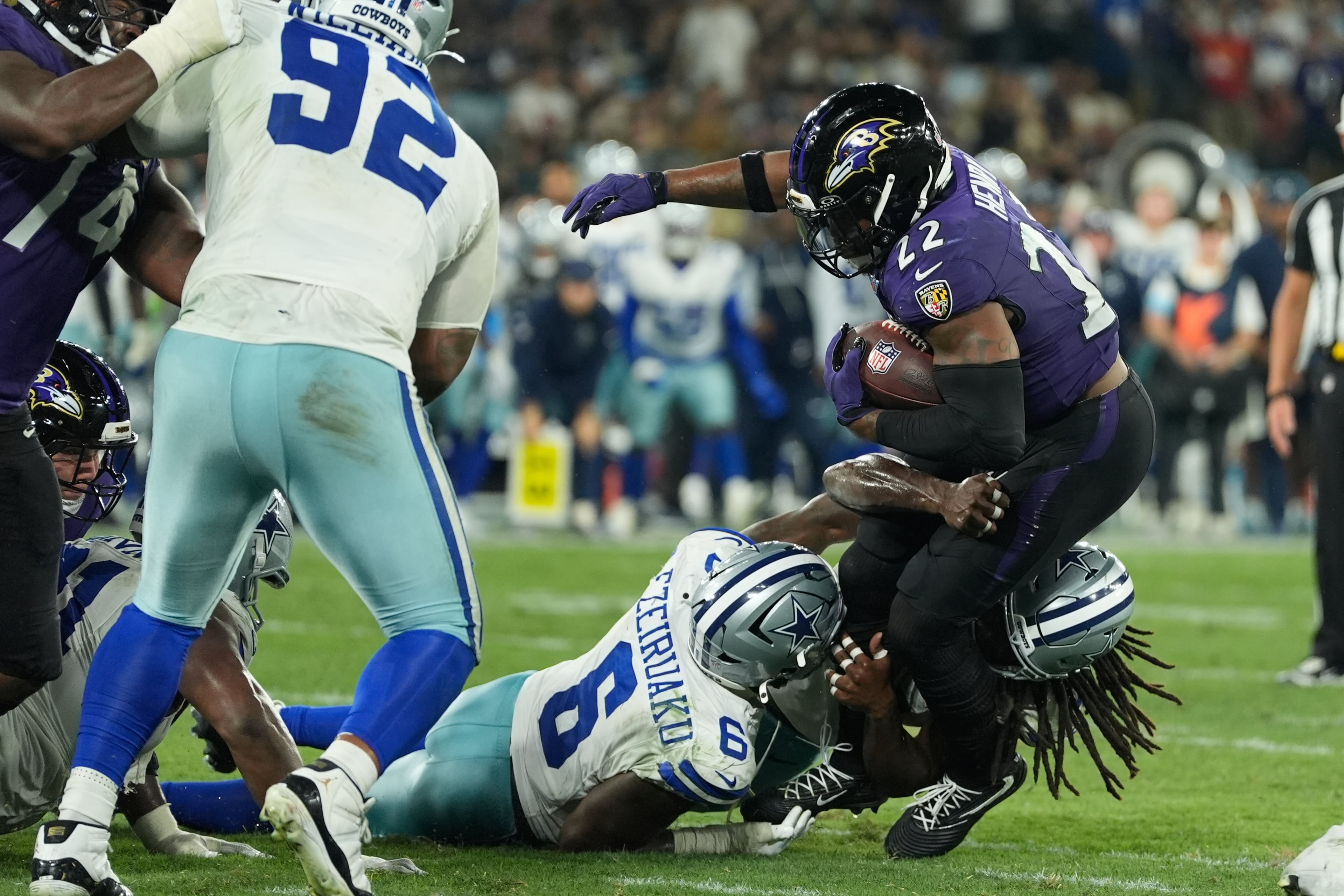 Ravens running back Derrick Henry (right) gets tackled by a couple of Cowboys during their recent game in Rio de Janeiro. (Fernando Llano/AP)