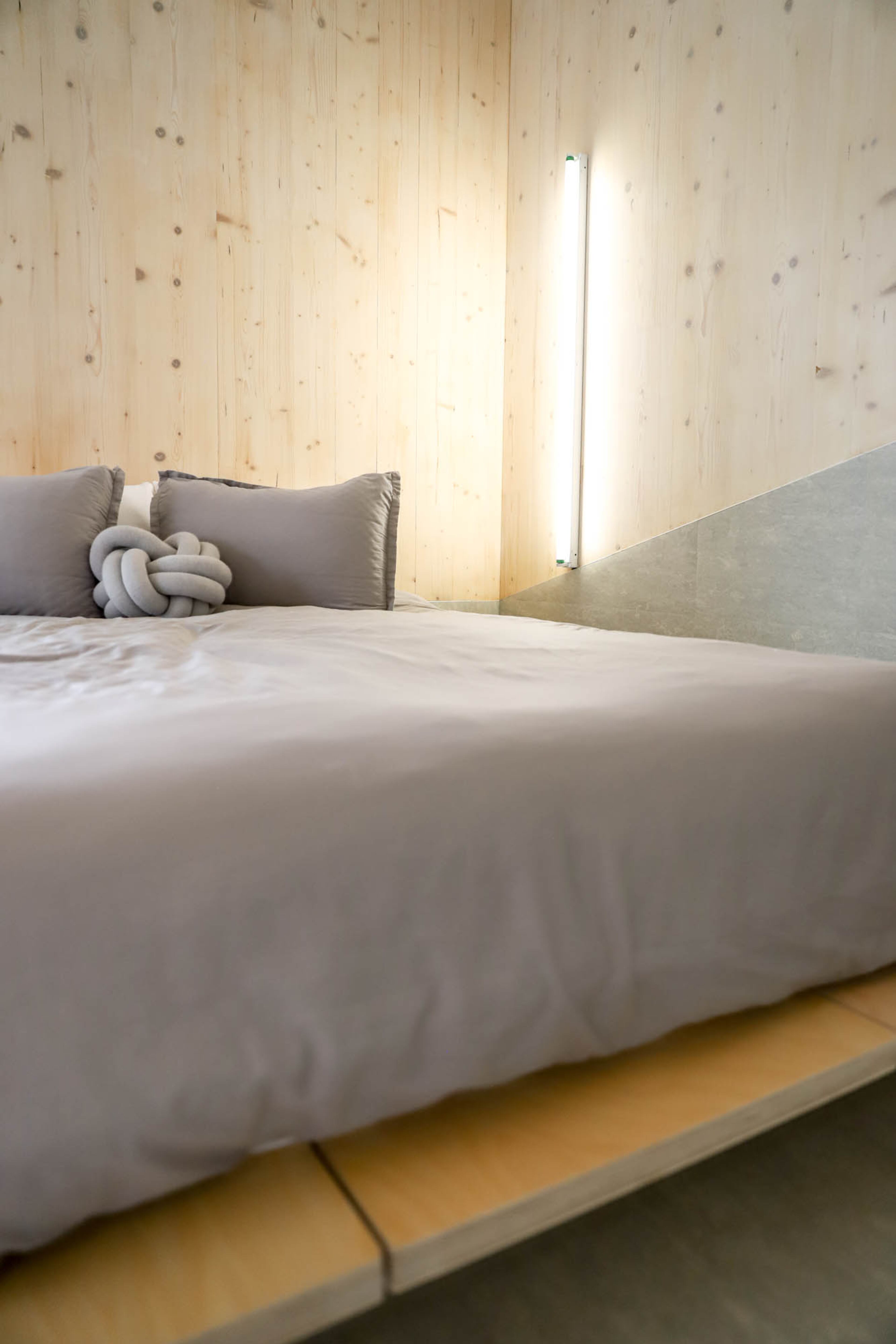 On the Floyd platform bed is the gray Knot pillow, which is designed by Ragnheiður (div)sp Sigurðardóttir for Design House Stockholm and purchased through DWR. "I tried to select and use as many female designers as possible," said homeowner Jennifer Bonner.