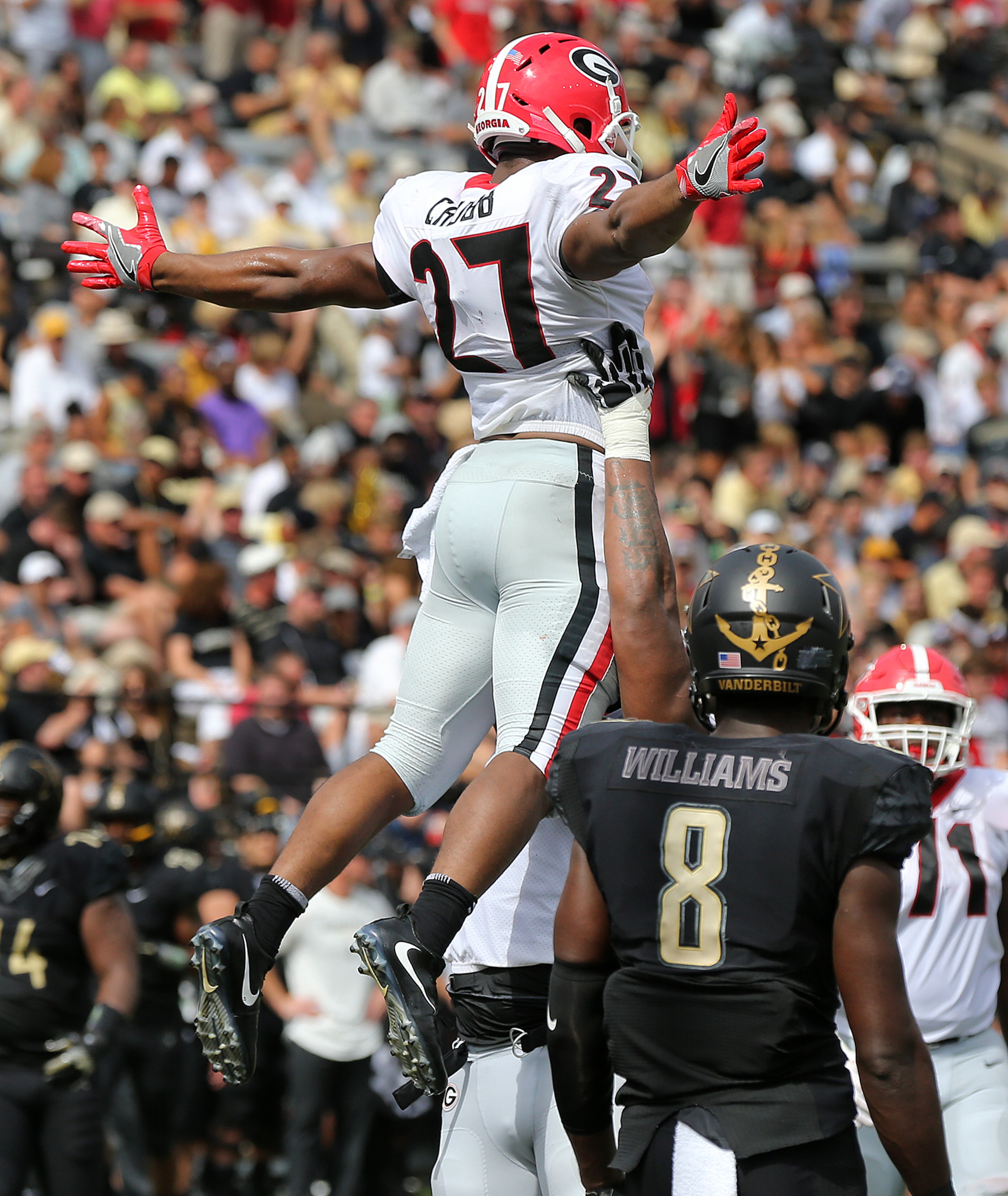 October 7, 2017 Nashville: Georgia tailback Nick Chubb gets a hoist in the air over Vanderbilt cornerback Joejuan Williams celebrating his second touchdown in the first half for a 21-0 lead in a NCAA college football game on Saturday, October 7, 2017, in Nashville. Georgia beat Vanderbilt 45-14. Curtis Compton/ccompton@ajc.com