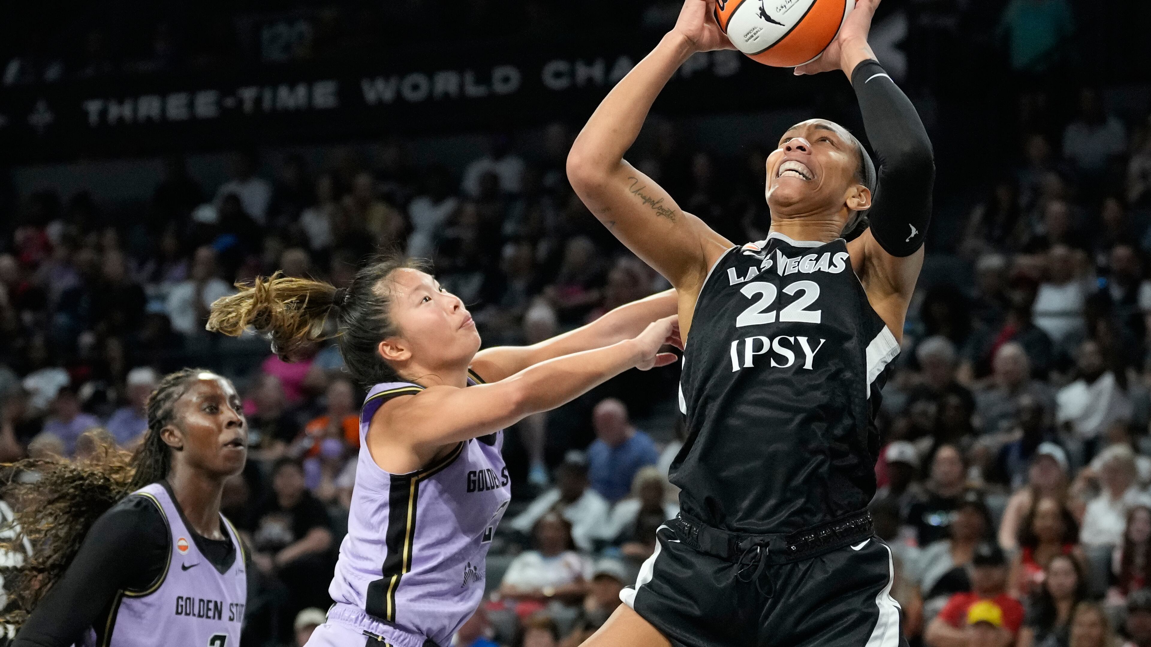 Las Vegas Aces center A'ja Wilson (22) grabs a rebound over Golden State Valkyries guard Kaitlyn Chen (2) during the second half of a WNBA basketball game Sunday, June 21, 2026, in Las Vegas. (AP Photo/John Locher)