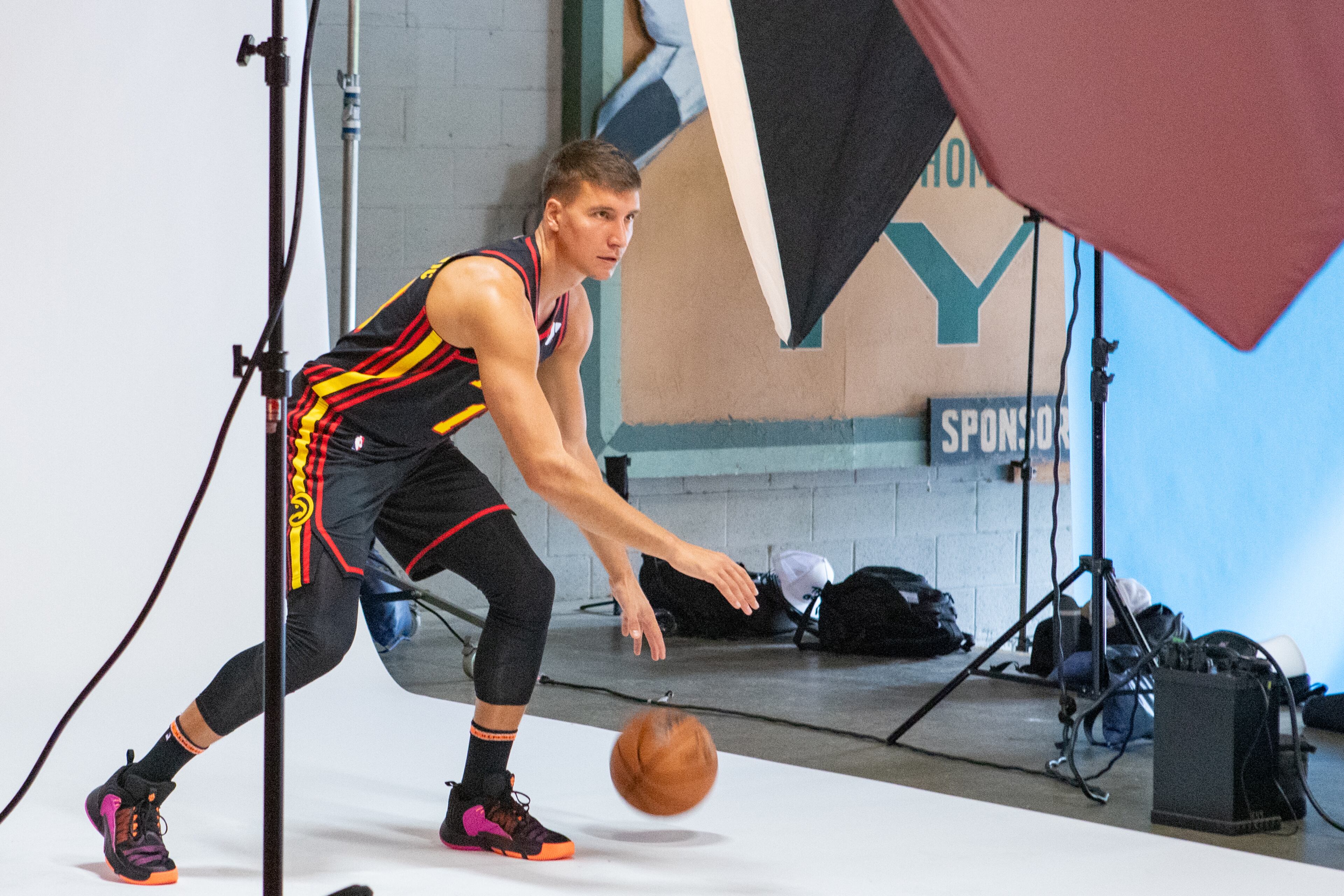 Hawks player Bogdan Bogdanovic dribbles for photographers. (Jenni Girtman for The Atlanta Journal-Constitution)