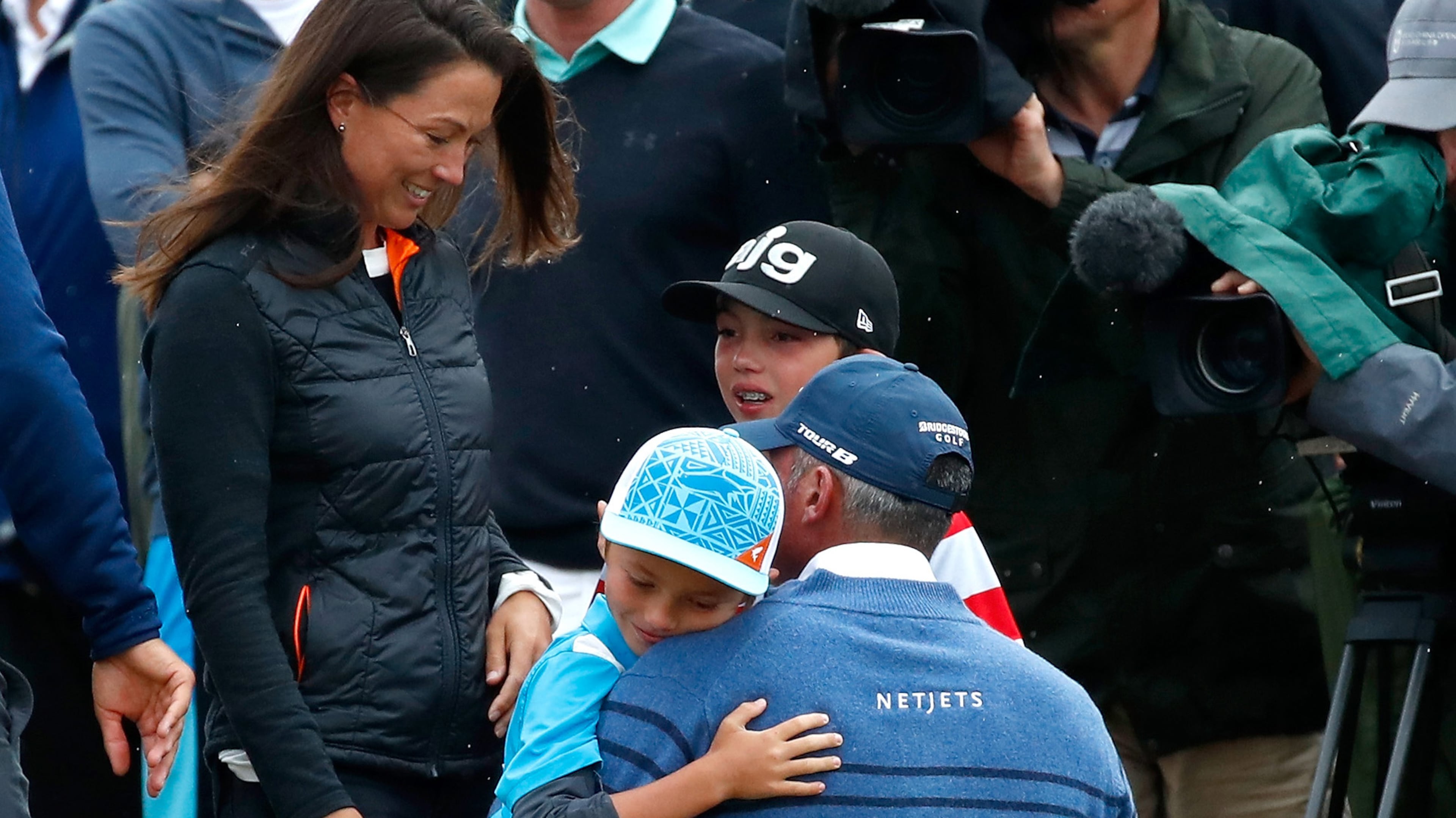 Matt Kuchar meets his children and wife, Sybi Kuchar, on the 18th green during the final round of the 146th Open Championship at Royal Birkdale on July 23, 2017, in Southport, England.