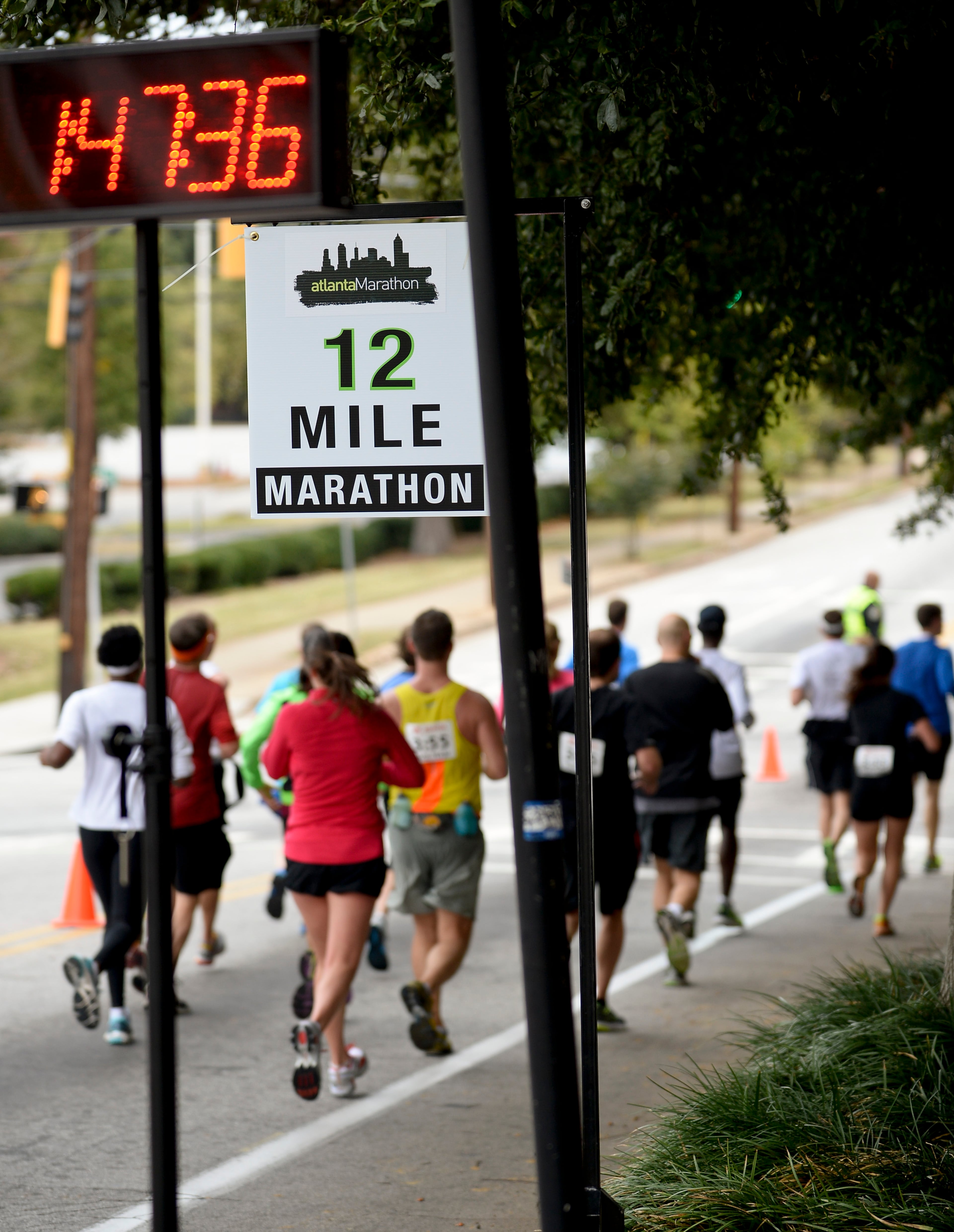 Runners pass the Jackson Street 12 mile mark during the 26-mile Atlanta Marathon on Sunday, Oct. 27, 2013, in Atlanta. David Tulis / AJC Special