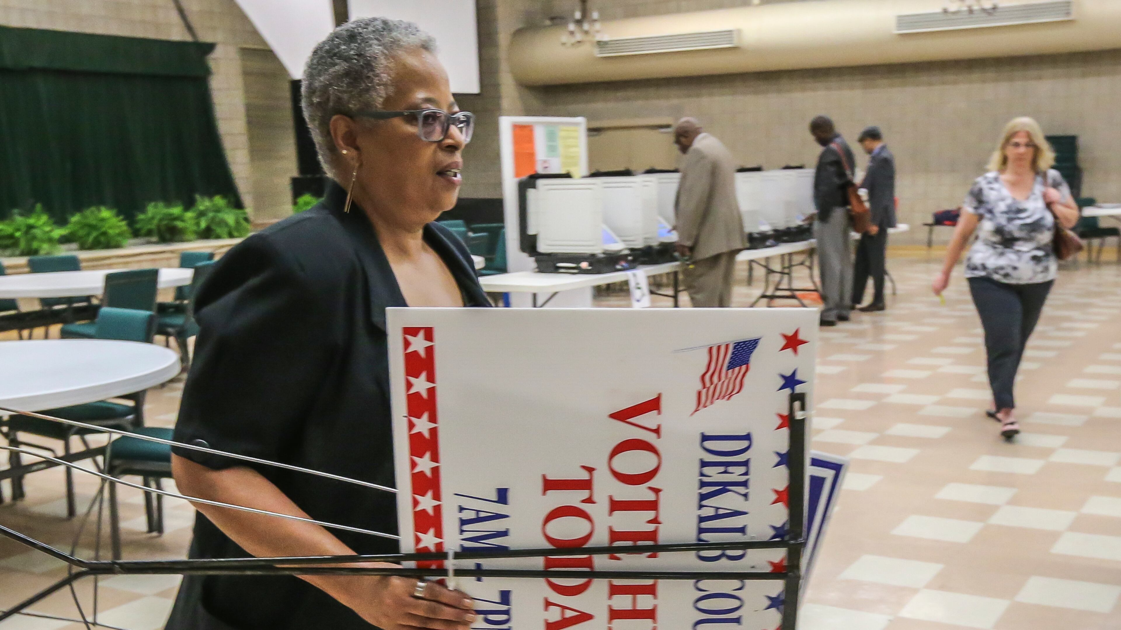 Poll manager Rosalind Smith gets ready to post signs as voters hit the voting machines at Mount Carmel Christian Church in Stone Mountain on Tuesday, May 24, 2016. JOHN SPINK / JSPINK@AJC.COM