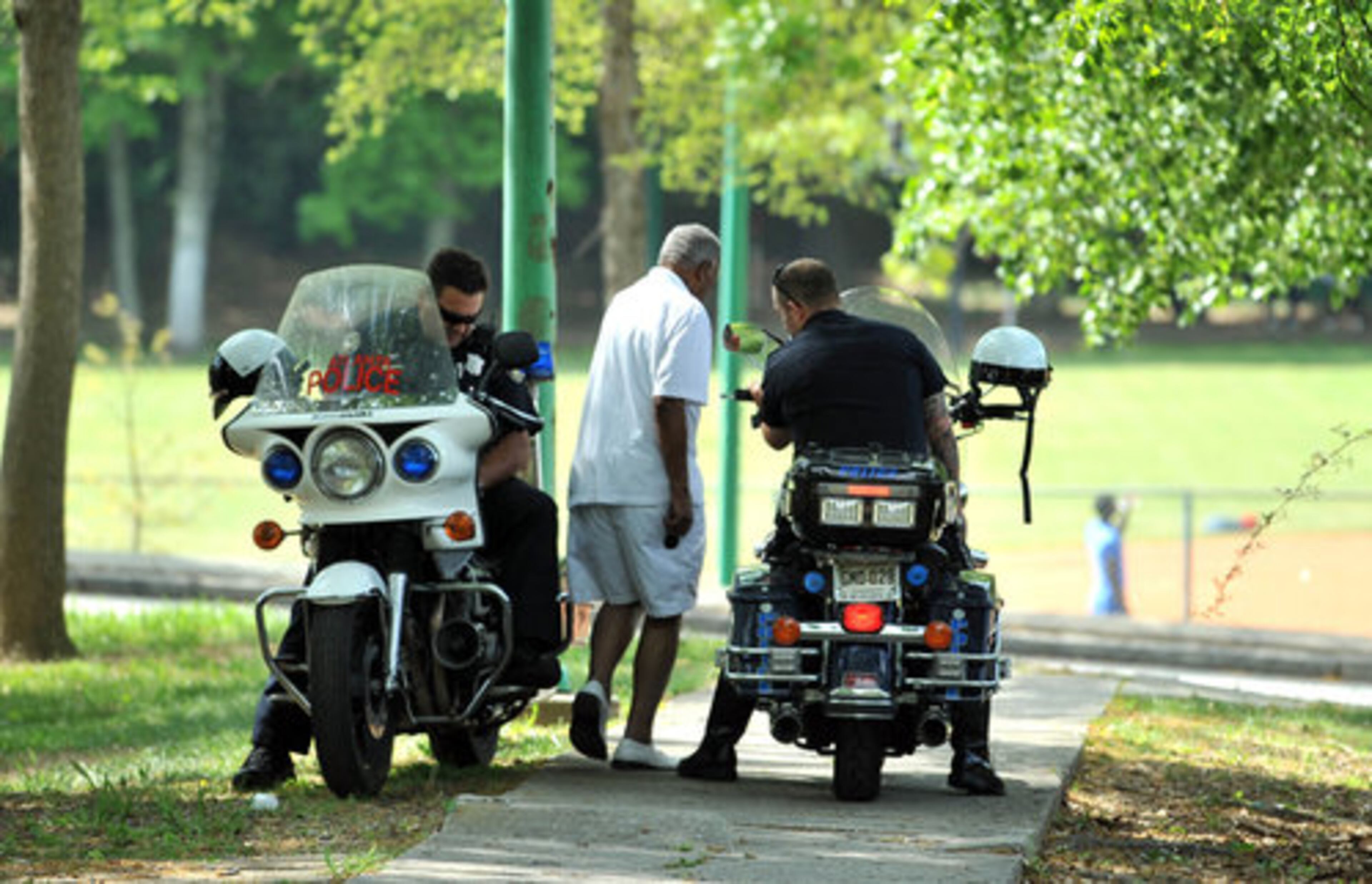 Atlanta Police officers watch to make sure things remain safe Saturday afternoon at the Washington Park in Atlanta.