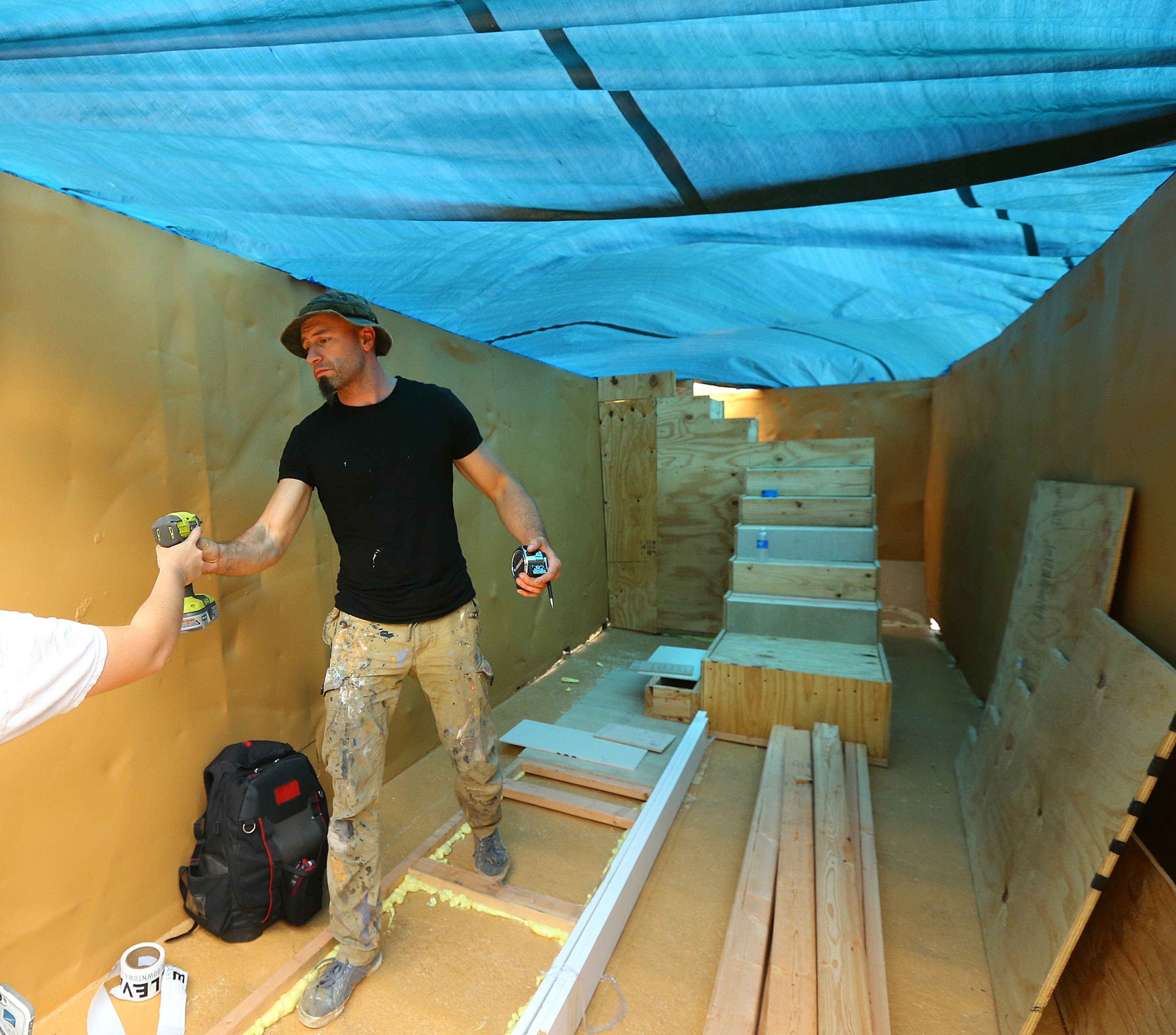 Artist Igor Korsunskiy transforms the interior of a dumpster into a contemplative piece called "Allusion" Monday, Oct. 13, 2014 at Woodruff Park in Atlanta. 20 artists were given 10 big trash receptacles to create a work of public art that will be part of this year's Elevate, the Office of Cultural Affairs' free week-long public art event from Oct. 17-23. CURTIS COMPTON / CCOMPTON@AJC.COM